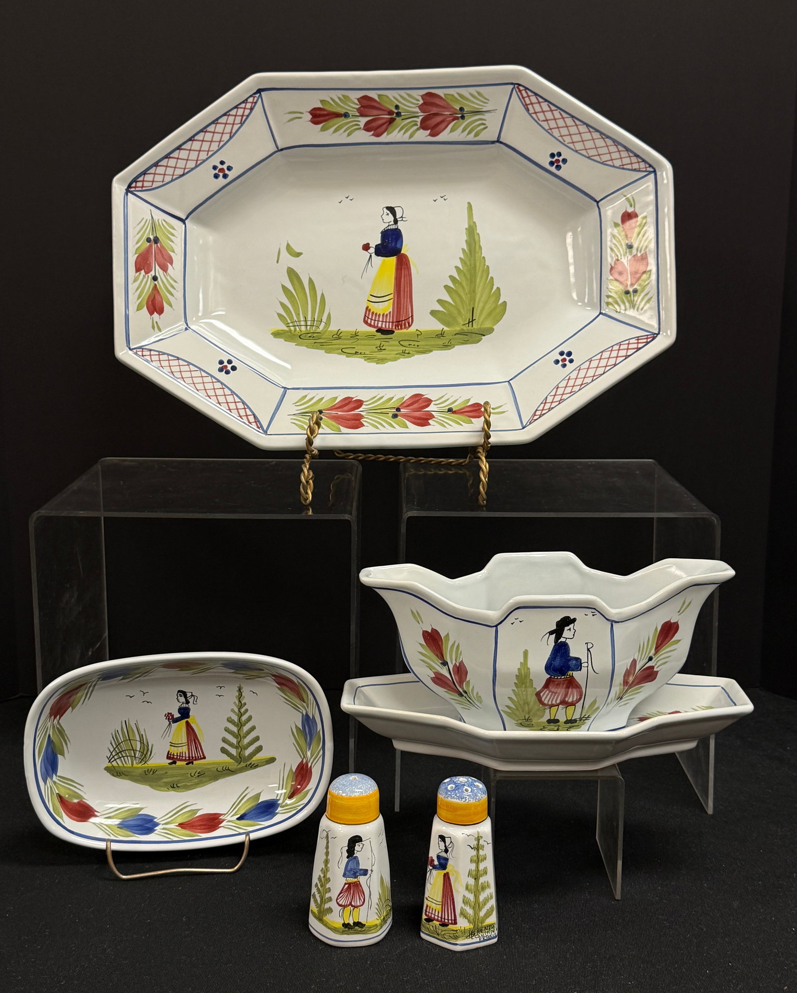 5 HB HenRiot Quimper Items: 5 HB HenRiot Quimper Mistral dinnerware items including a rectangular platter with Bretonne, a gravy boat with attached underplate with a Breton, a rounded rectangular deep dish with Bretonne and