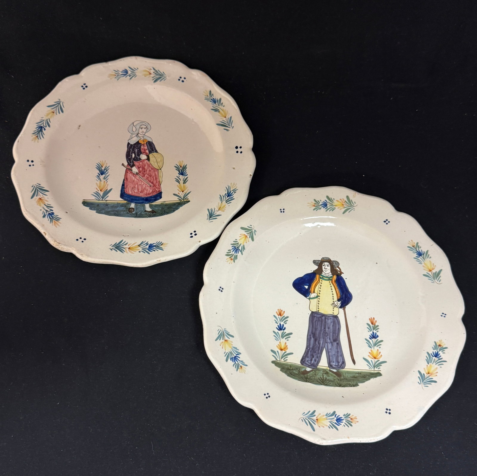 Pair of HB Plates: Pair of HB plates with delicate border sprays and 4 dot motifs surrounding a Breton and Bretonne; diameter 9 1/2" circa 1883-1904. CONDITION: Quimper has propensity to have minor chips, glaze