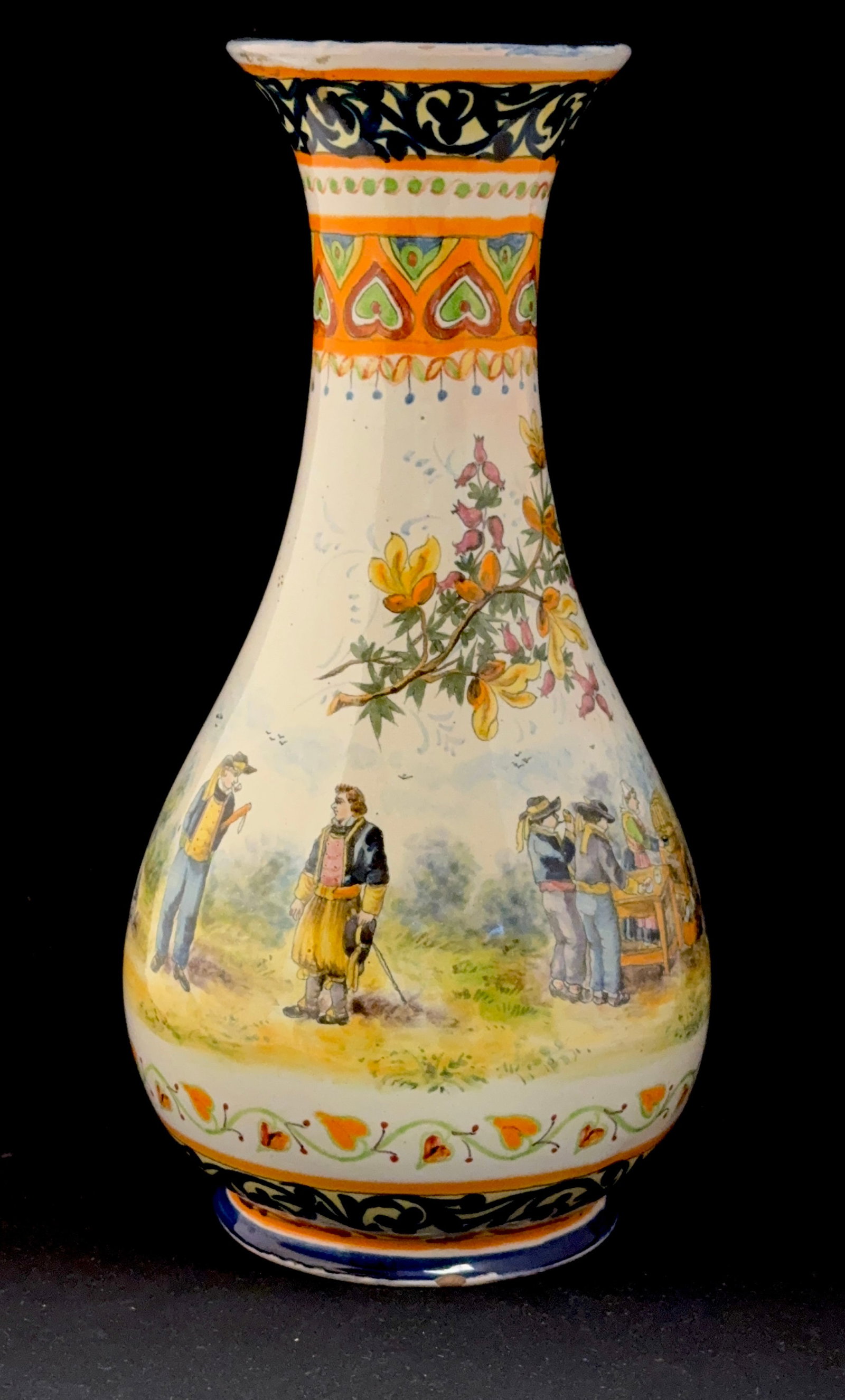 HB Quimper Tall Vase: Exceptional tall HB Quimper vase with flared neck, Celtic motif, Blason of Brittany also decorated with scenes of Bretons drinking cider, in conversation, a dog, and observing a sacred moment