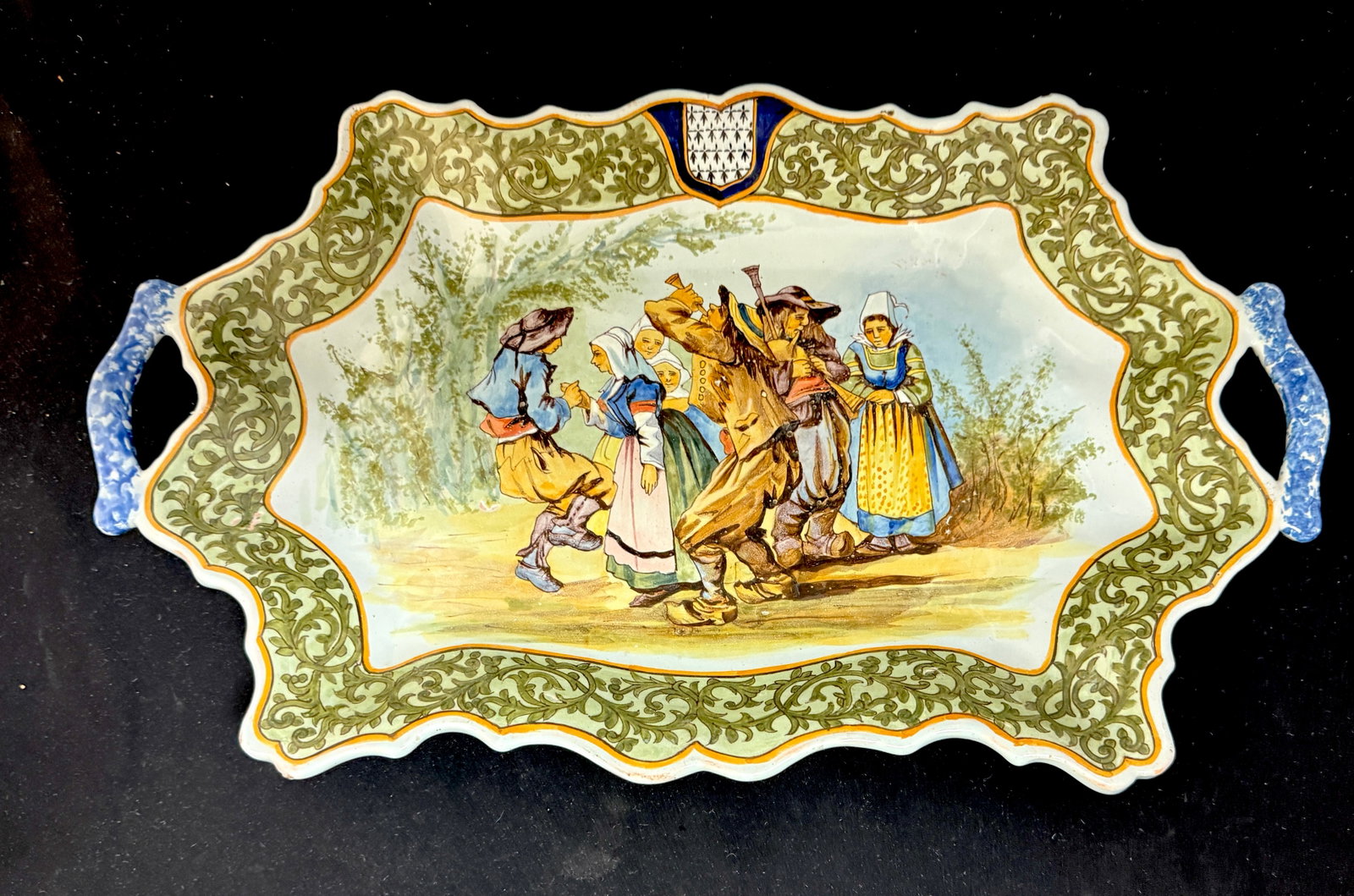 Porquier Beau Bannette: Porquier Beau bannette with sponged handles, d?cor riche border and Blason of Brittany surrounding a festive Breton scene of musicians and dancers; length 17 1/4" circa 1875-1905. LITERATURE: Tome II