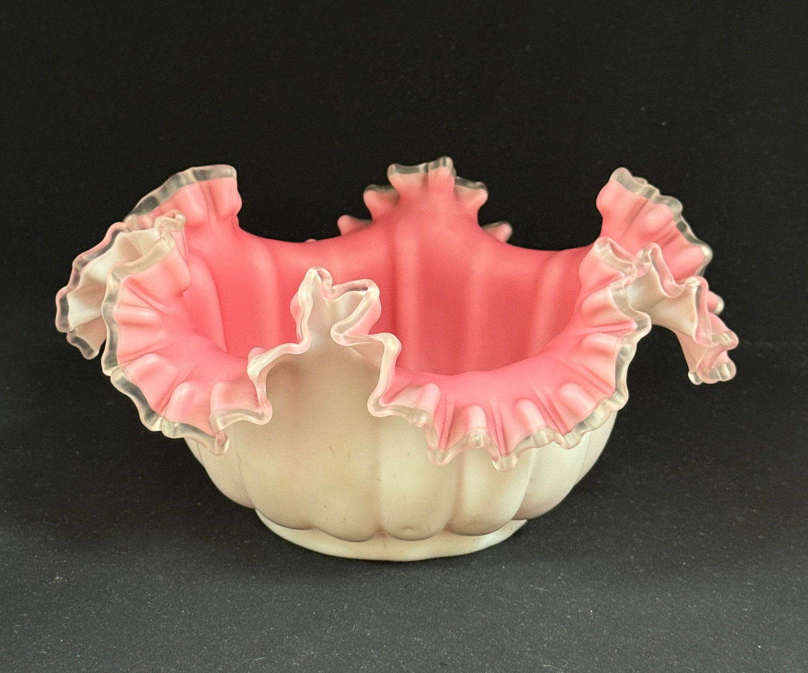 Large Ruffle Top Bride's Basket: Large ruffle top ribbed Bride's bowl, white exterior, pink interior; diameter 10 1/2". PROVENANCE: Carol Lange, granddaughter of William Davidson founder of Harley Davidson. CONDITION: no chips,