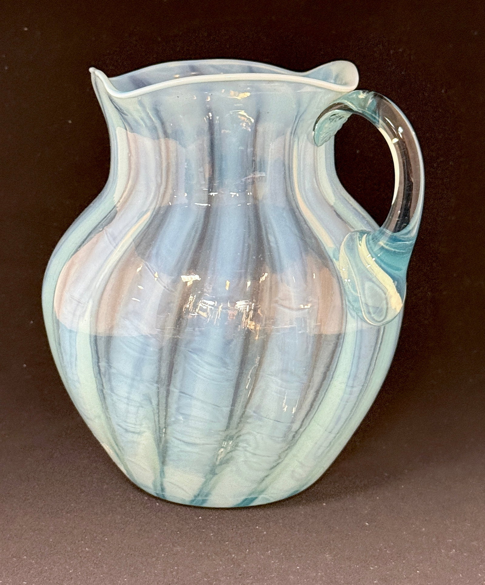 Blue Opalescent Water Pitcher: Blue Opalescent water pitcher with a quad-ra-fold rim, 8" ht. CONDITION: no chips, cracks, repairs or material defects found, Jaremos attempts to call any material flaw that affects the price, but