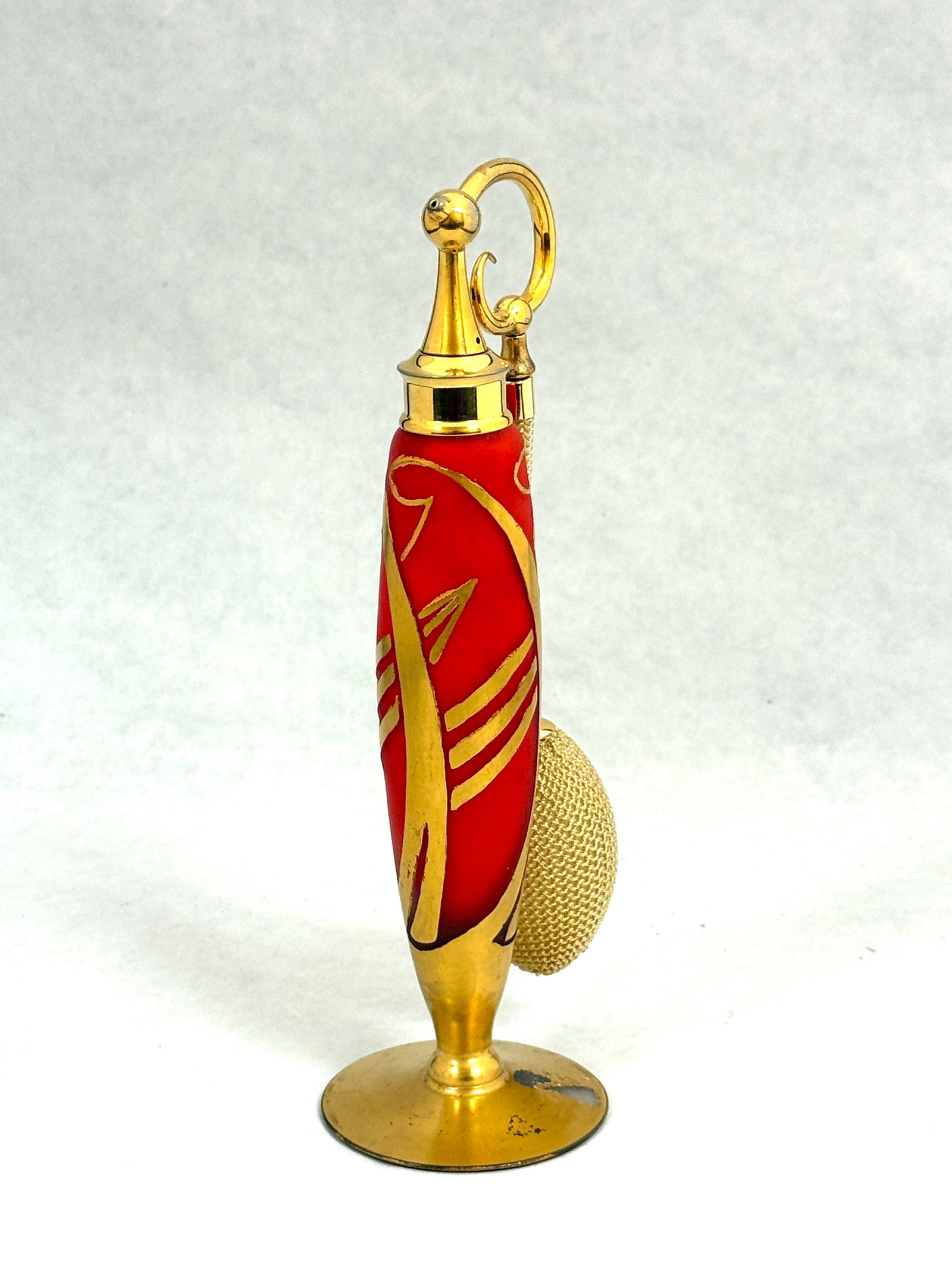 DeVilbiss Elegant Red Perfume: DeVilbiss Elegant Line red atomizer decorated with Art Deco leaves, rams head stopper, 7 1/2" ht. CONDITION: minor enamel loss to foot, no chips, cracks, repairs, or material defects found, Jaremos
