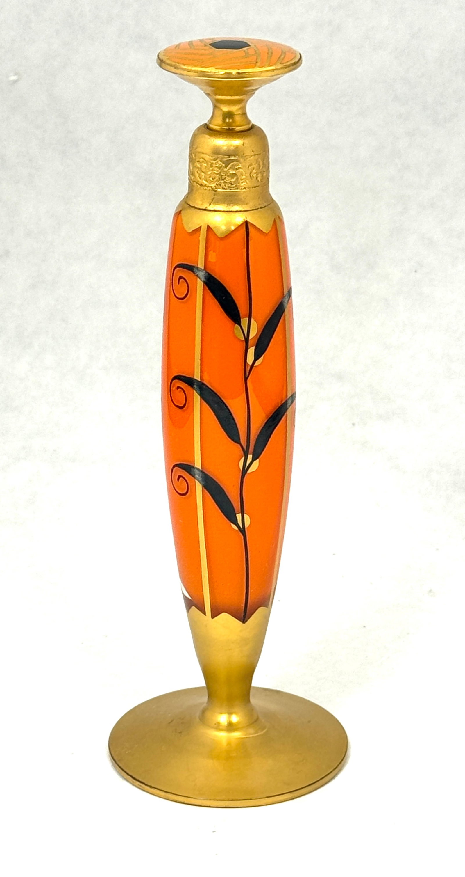 DeVilbiss Orange Perfume: DeVilbiss orange Perfume with a leaf design and a enameled stopper, signed DeVilbiss, 7" ht. CONDITION: no chips, cracks, repairs, or material defects found, Jaremos attempts to call any material