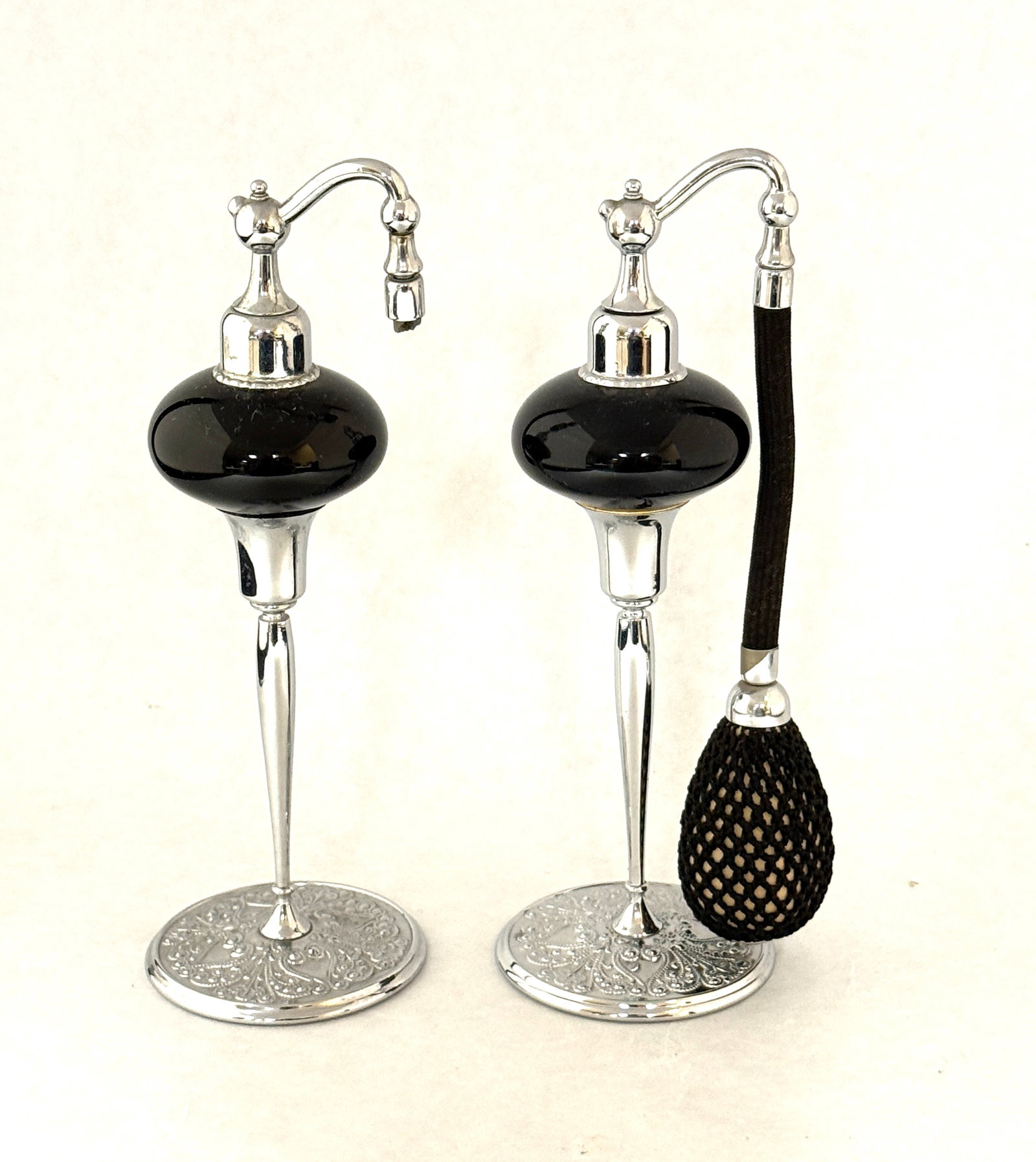Two DeVilbiss Black Perfumes: Two DeVilbiss black and chrome perfume atomizers, 7" ht. CONDITION: no chips, cracks, repairs, or material defects found, Jaremos attempts to call any material flaw that affects the price, but minor