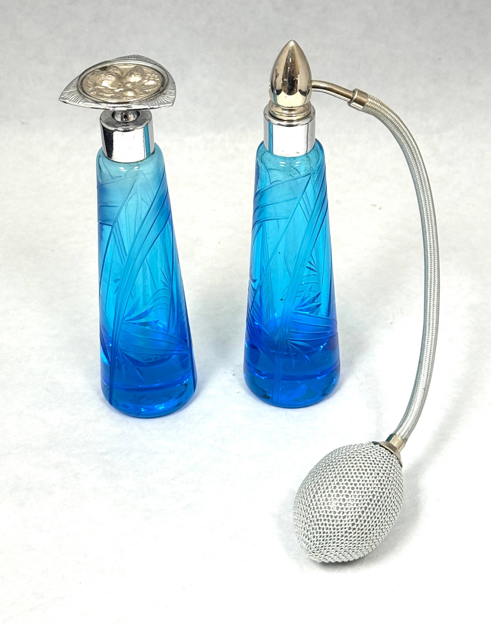 Two DeVilbiss Cut Glass Perfumes: Two DeVilbiss blue Cut glass perfumes, 6" ht. CONDITION: no chips, cracks, repairs, or material defects found, Jaremos attempts to call any material flaw that affects the price, but minor scratches