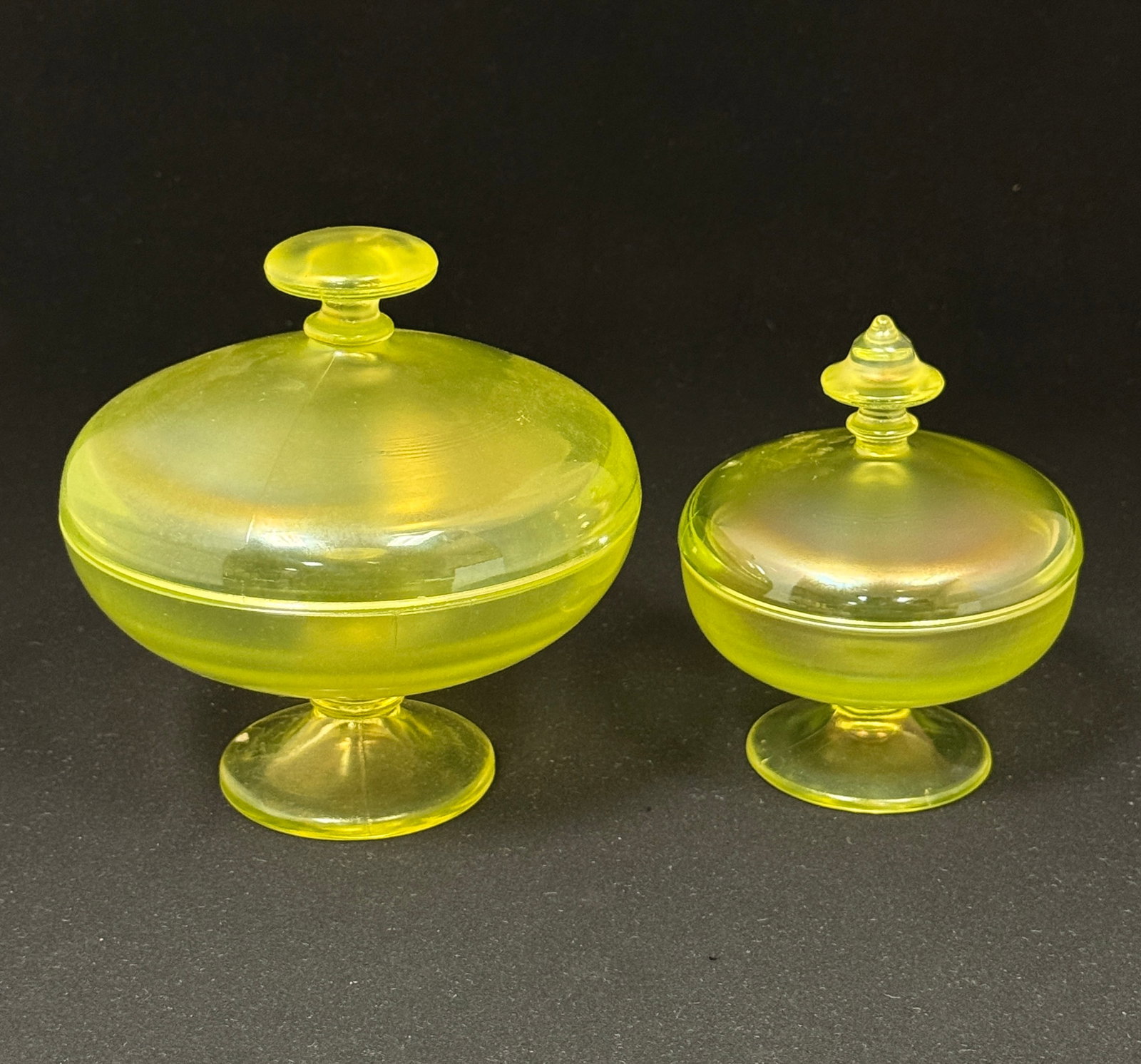 Two Fenton Vaseline covered jars: Two Fenton vaseline covered compotes, tallest 5 1/2" ht. CONDITION: no chips, cracks, repairs, or material defects found, Jaremos attempts to call any material flaw that affects the price, but minor