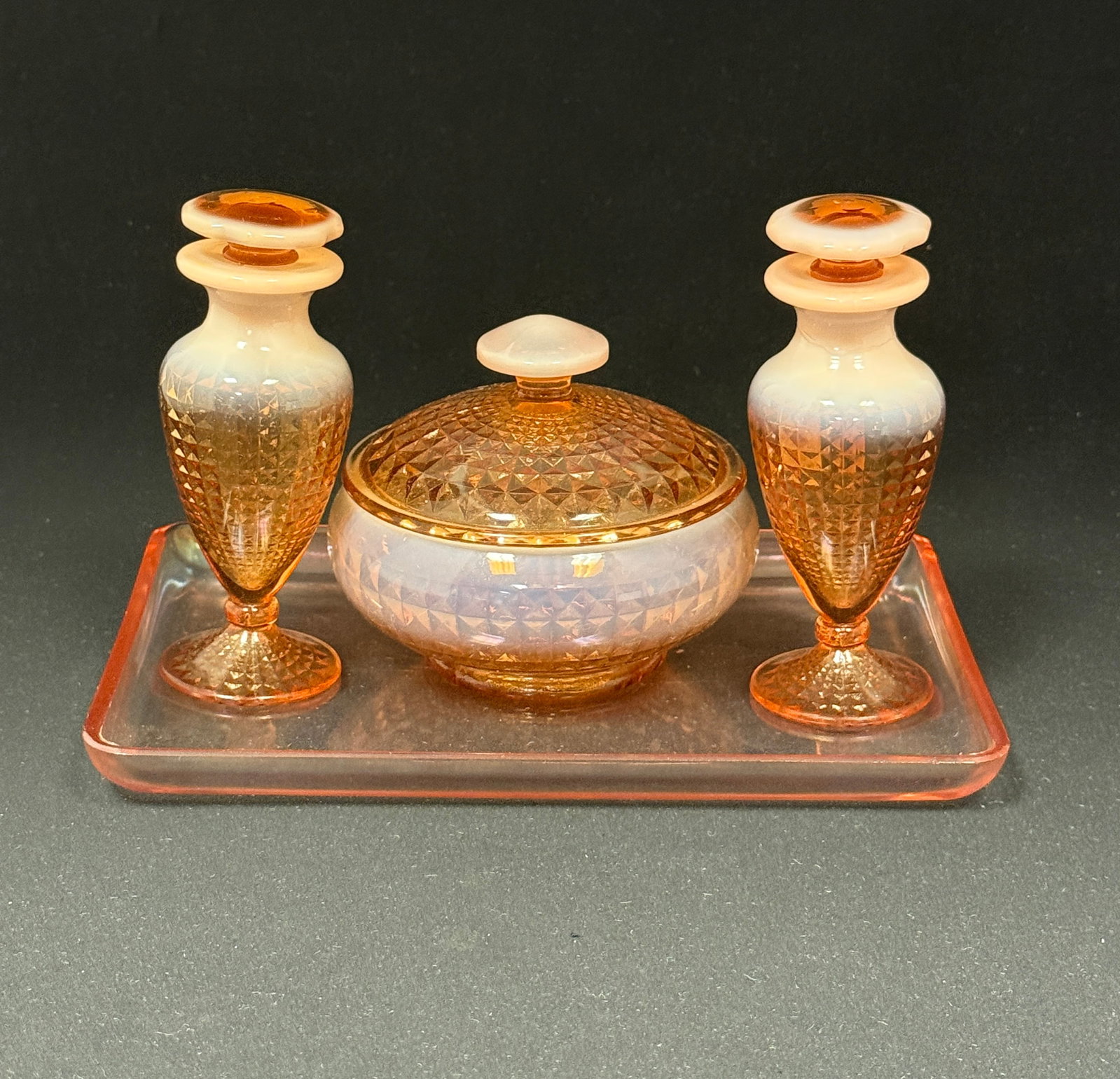 Fenton Opalescent Bath Set: Fenton Peach Opalescent "Cameo Opal" bath set consisting of a tray two perfumes and a jar, 8 1/2" long. CONDITION: one bottle with repair