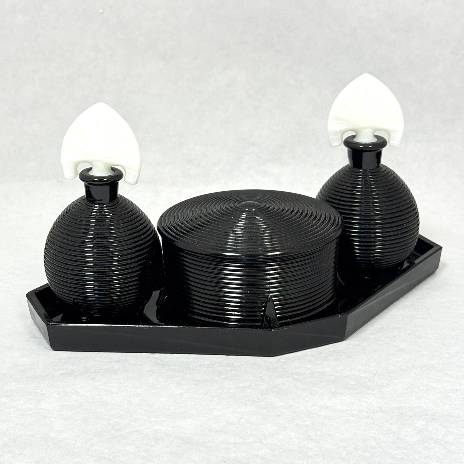Imperial Dolly Madison Bath Set: Imperial black Dolly Madison Bath set including a covered jar and two perfumes with white stoppers, 9" long. CONDITION: no chips, cracks, repairs, or material defects found, Jaremos attempts to call