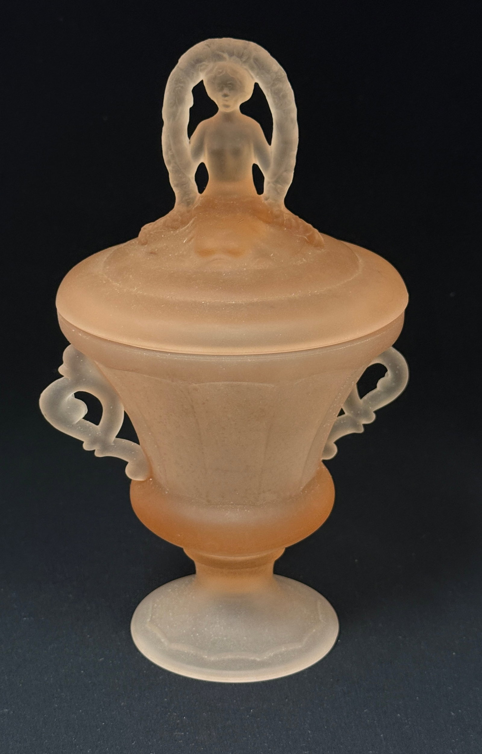 Large Covered Compote: Frosted Peach covered compote in the 'Nymph" pattern, 9 1/2" ht. LITERATURE: "Bedroom & Bathroom Glassware" by Whitmyer page 39. CONDITION: no chips, cracks, repairs, or material defects found,
