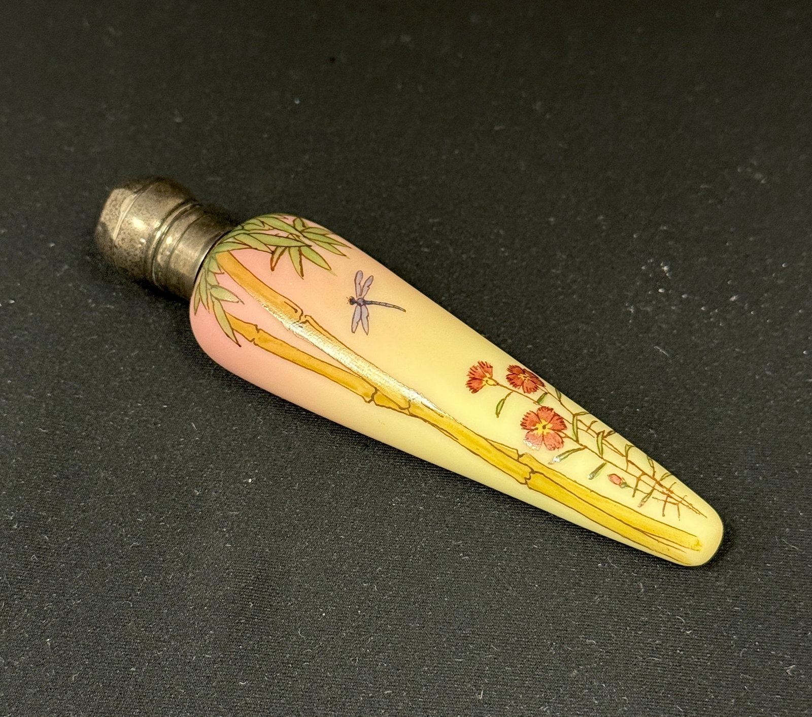 Webb Burmese Perfume: Webb tear drop form uranium based Burmese glass decorated with bamboo and a dragon fly, hallmark sterling lid, 5" long. CONDITION: dent to the lid. no chips, cracks, repairs, or material defects found