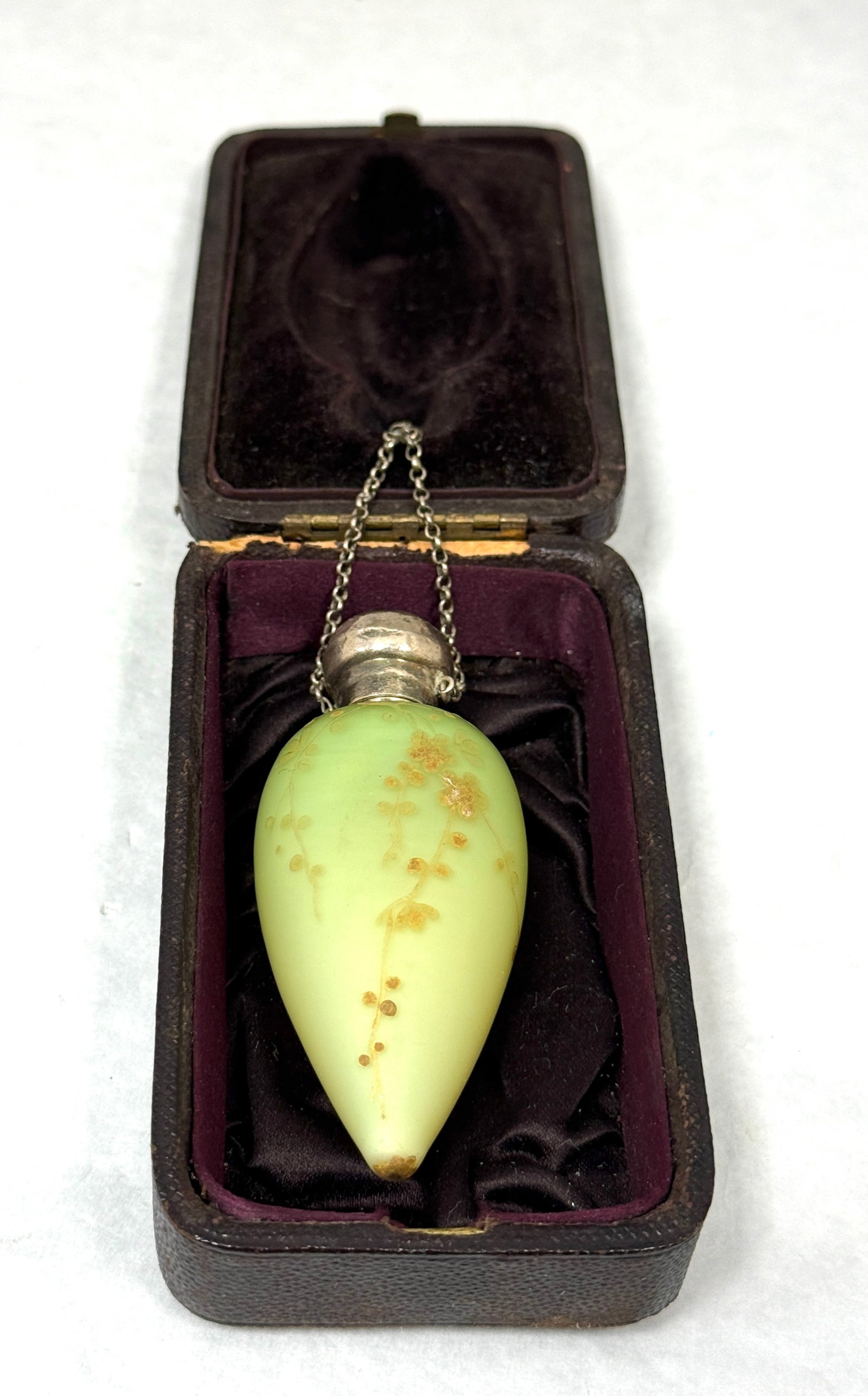 Webb Tear Drop Perfume: Webb tear drop perfume in green satin glass with gold flowers set in a fitted leather case, 3" ht. CONDITION: no chips, cracks, repairs, or material defects found, Jaremos attempts to call any materia