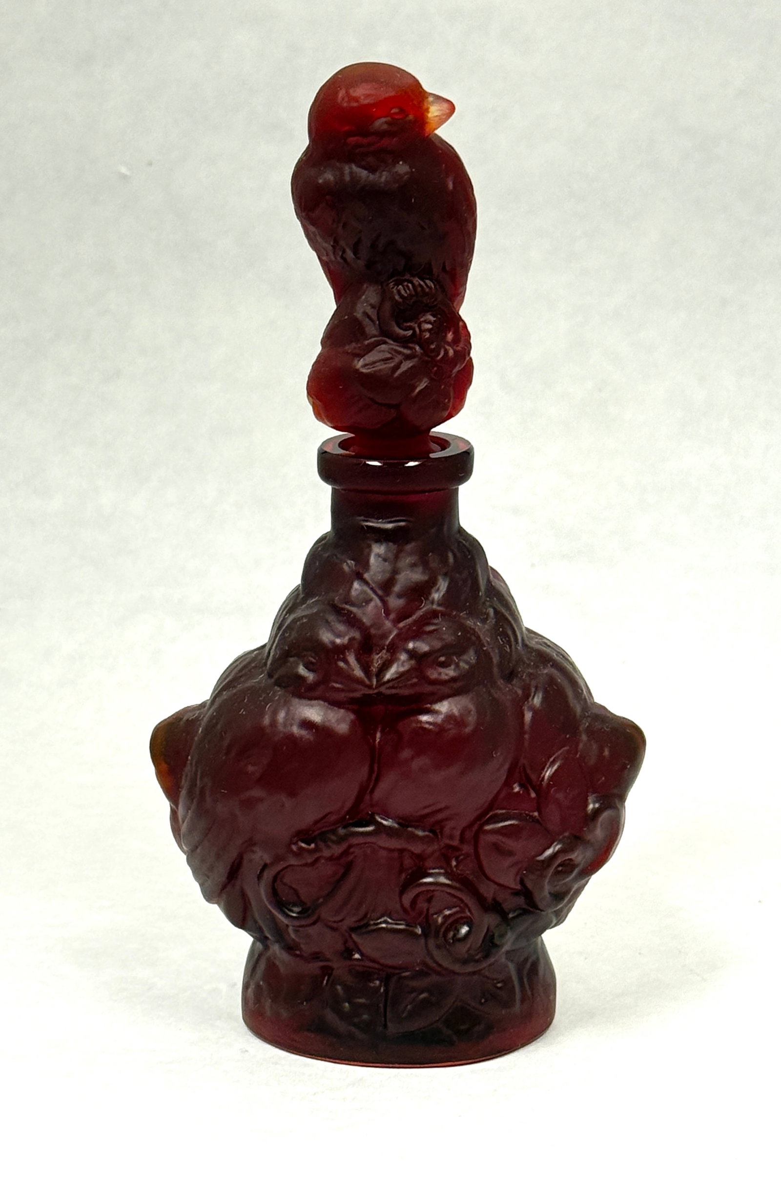 Hoffmann Sculptured Bottle: Heinrick Hoffman sculptured bottle with a bird finial, uranium based glass, 7 1/2" ht. CONDITION: no chips, cracks, repairs, or material defects found, Jaremos attempts to call any material flaw that