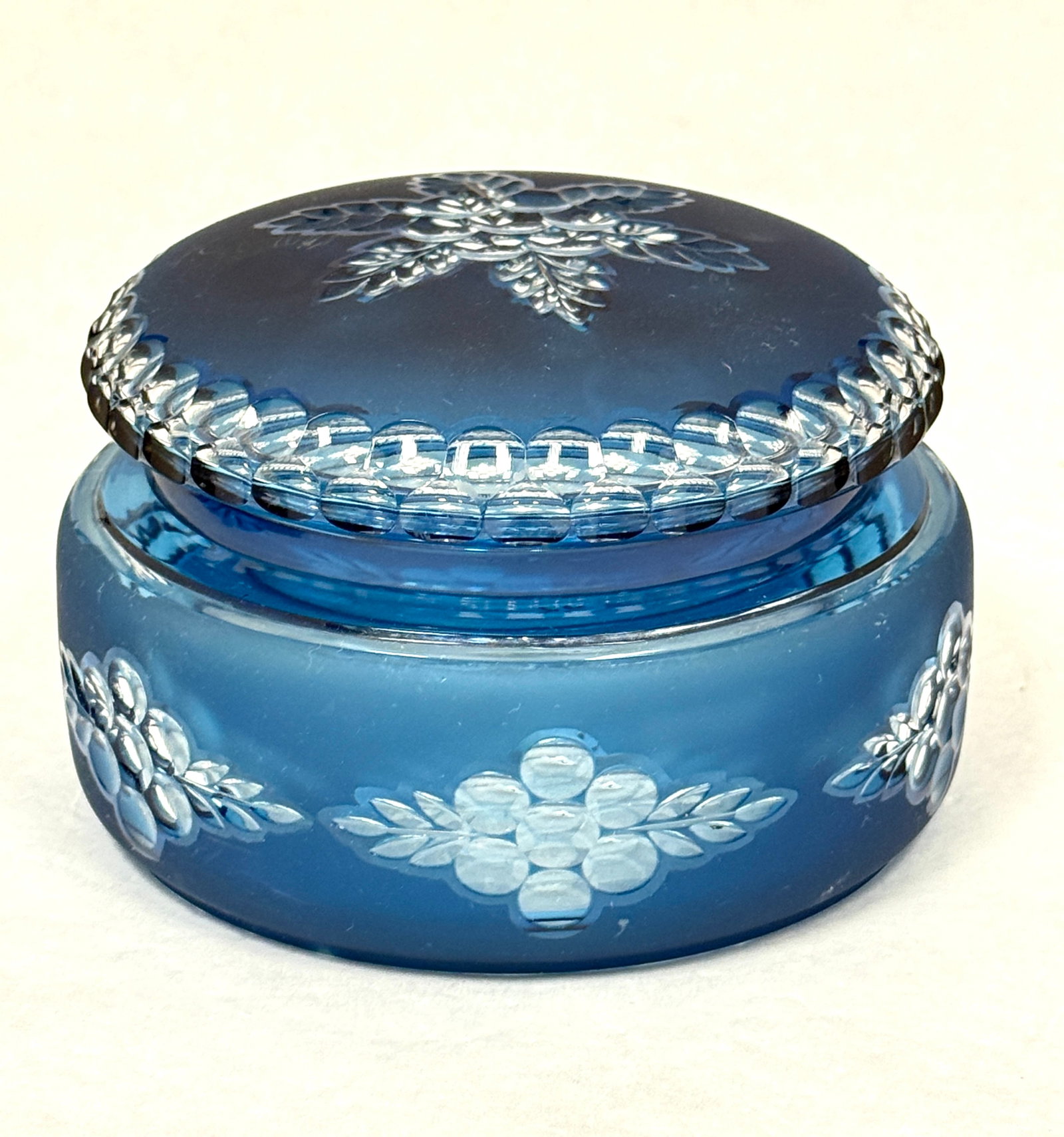 Blue Val St. Lambert Powder Box: Blue cut glass powder box with a central star pattern flower and a circle cut rim, 5 1/2" wide. CONDITION: no chips, cracks, repairs, or material defects found, Jaremos attempts to call any material