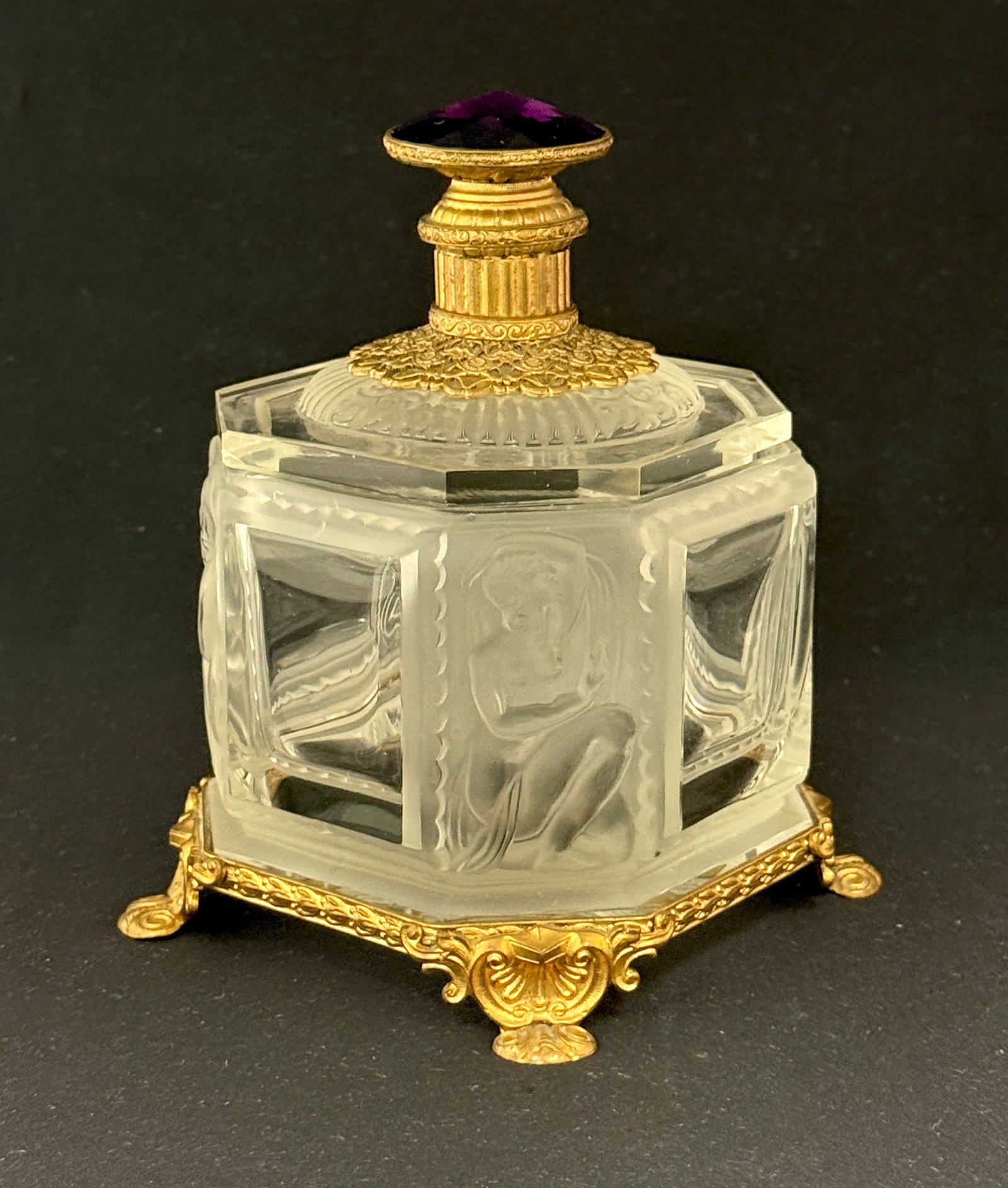 Baccarat Dresser Box: French Baccarat frosted dresser box with nude figures fitted with gold Ormolu feet and top with a purple finial, 5 1/2" ht. CONDITION: no chips, cracks, repairs, or material defects found, Jaremos