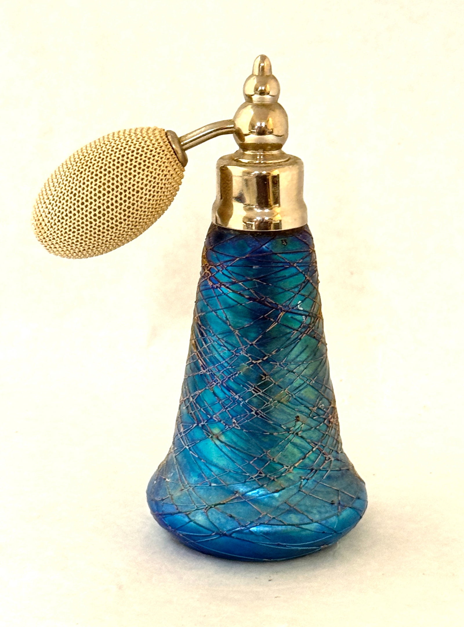 Durand Blue Threaded Perfume: Durand iridescent blue perfume atomizer with overall blue threading, 5 1/4" ht. CONDITION: no chips, cracks, repairs, or material defects found, Jaremos attempts to call any material flaw that