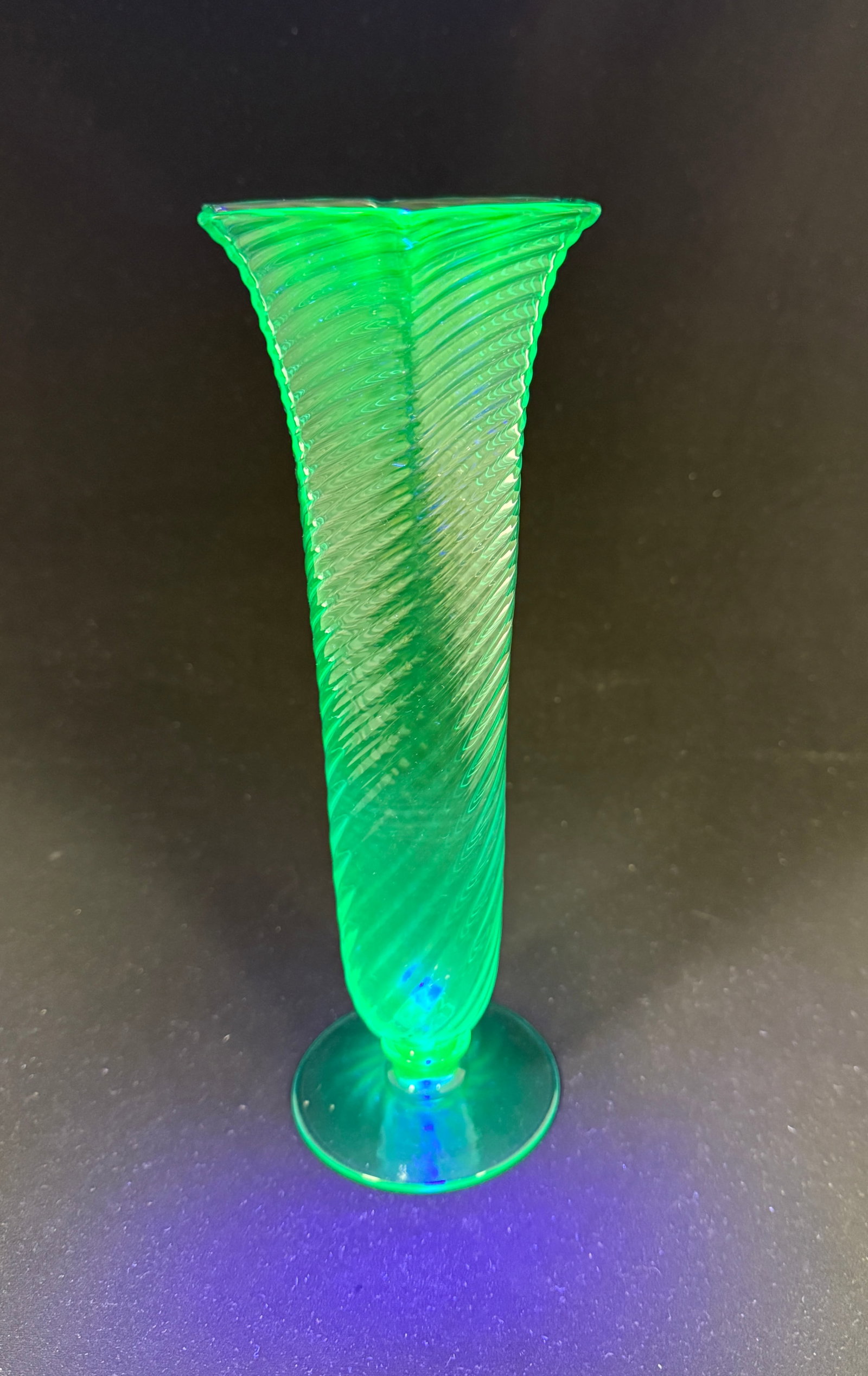 Steuben Blue Uranium Vase: Steuben Marina Blue Uranium flower vase twisted form with a hexagon rim, signed with block letters Steuben, 10" ht. NOTE: Marina is a mix of Pomona Green and French Blue thus the glow. CONDITION: no