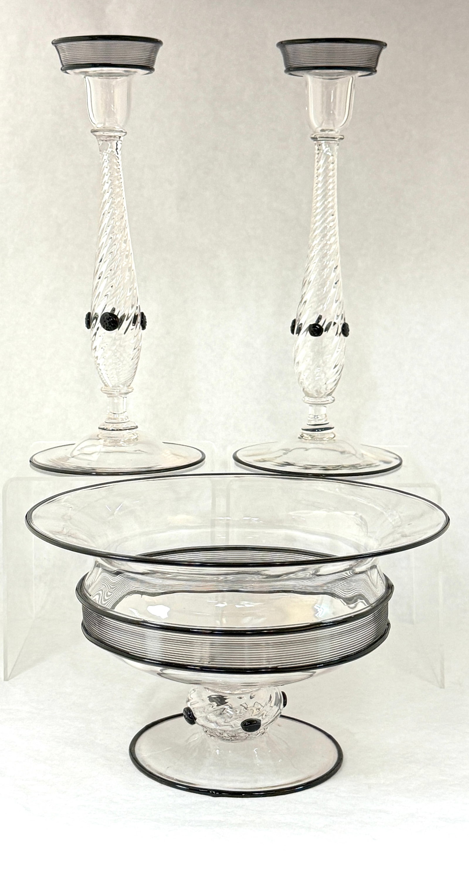 Steuben Mirror Black Console Set: Steuben clear and mirror black console set including a translucent central bowl and two matching candlesticks each with controlled black threading and prunts, tallest 12" ht. CONDITION: no chips,