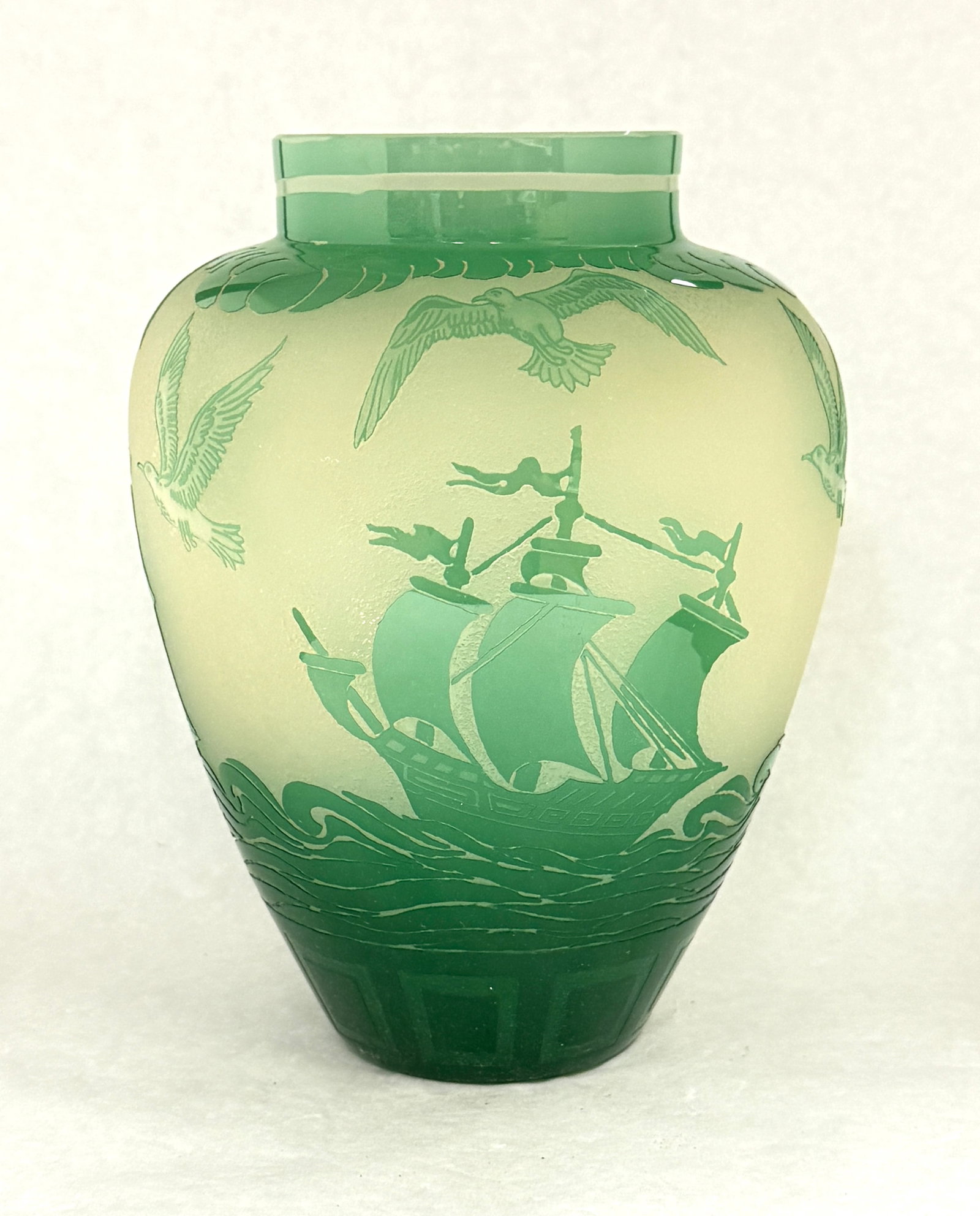Steuben ACB Ship Vase: Steuben acid cut back shouldered vase in opal decorated with a green Jade ship and sea bird three times around the vase, 10" ht. CONDITION: no chips, cracks, repairs or material defects found,