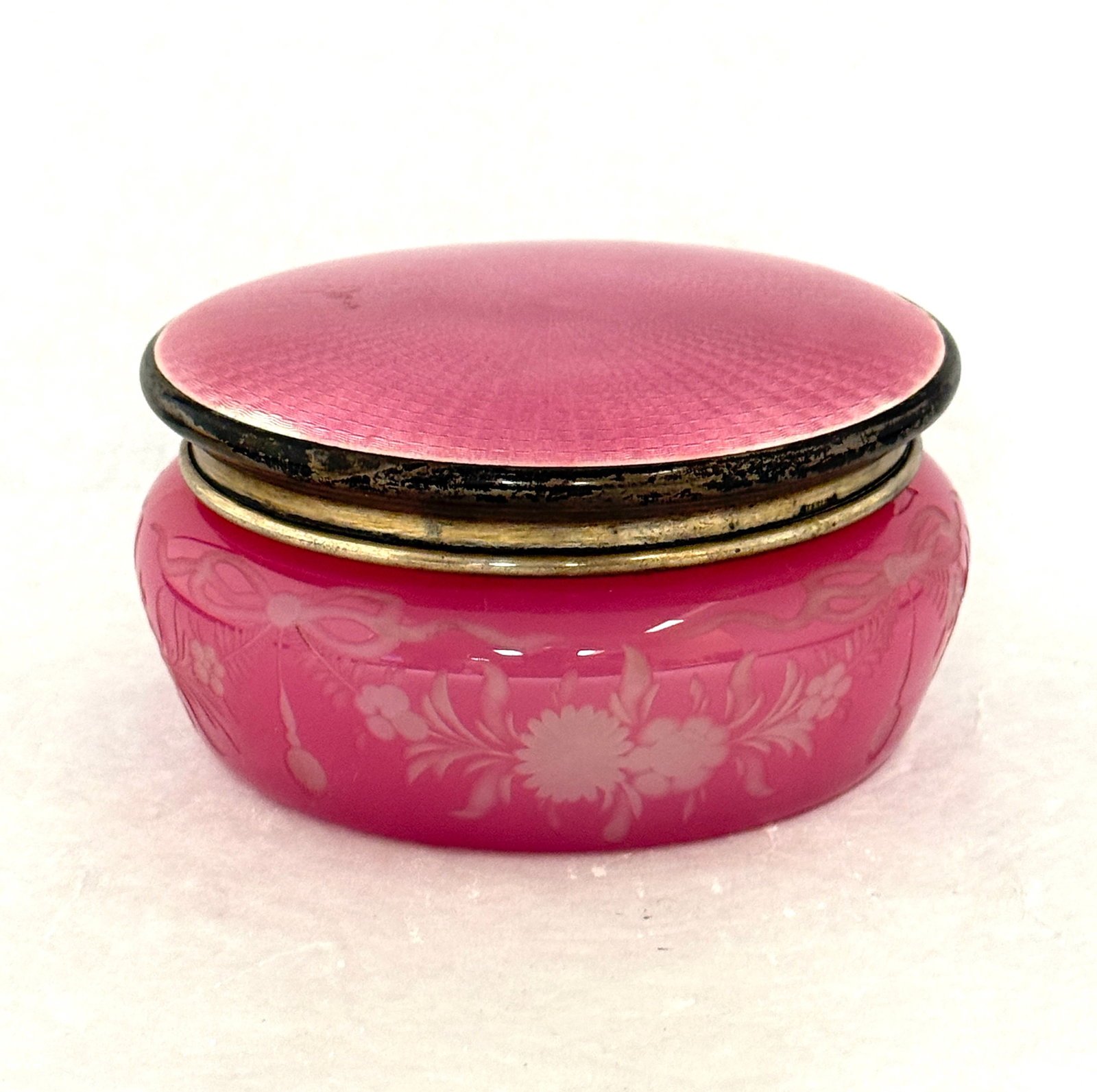 Steuben Rosaline Dresser Box: Steuben Rosaline dresser box with a cut band of draped flowers adorned with a pink sterling Guilloche lid, 5 1/4" wide. CONDITION: no chips, cracks, repairs or material defects found, Jaremos
