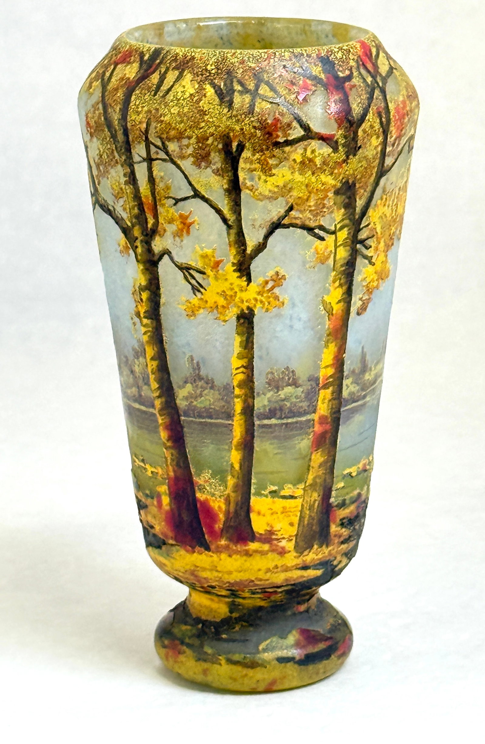 Daum Nancy Scenic Cameo: Daum Nancy French cameo fall scene of tall yellow and red trees towering over a light blue lake with a distant forested shoreline, signed Daum Nancy 6" ht. CONDITION: no chips, cracks, repairs, or mat