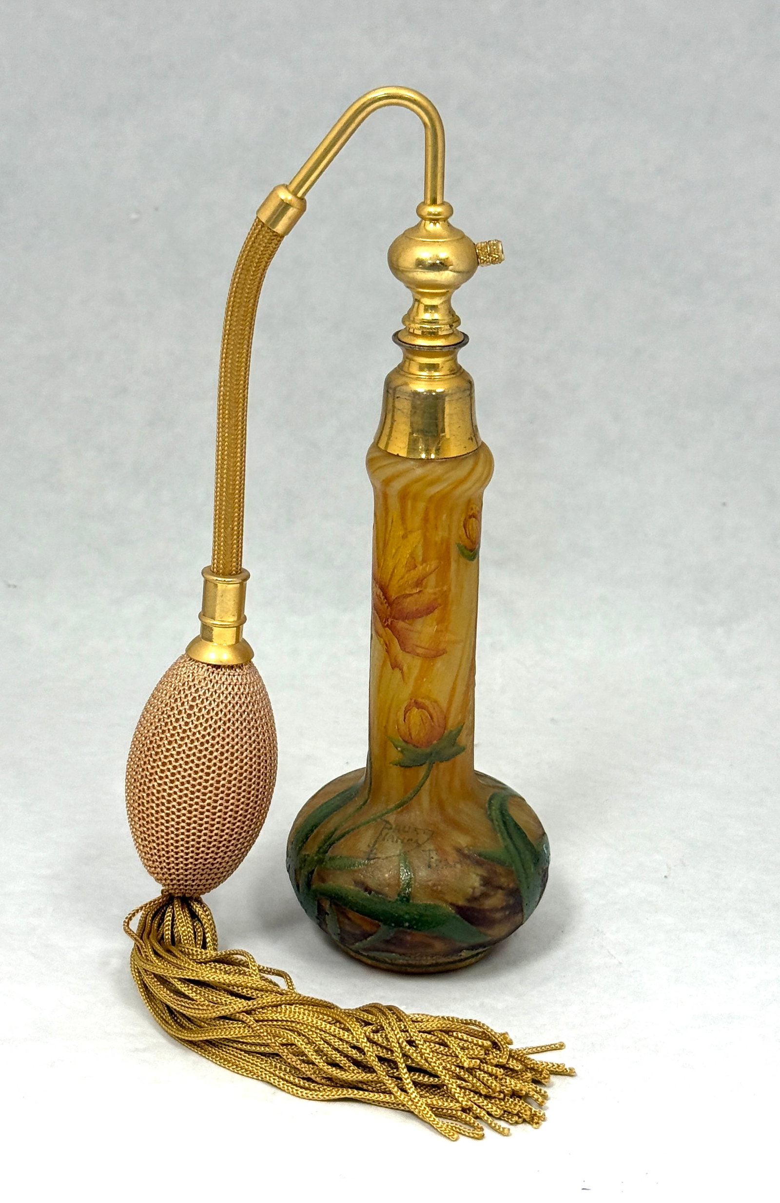 Daum Nancy French Cameo Bottle: Daum Nancy French cameo perfume atomizer in mottled yellow glass decorated with yellow flowers on green stems signed Daum Nancy, 7" ht. PROVENANCE: Christies Auction. CONDITION: no chips, cracks, repa