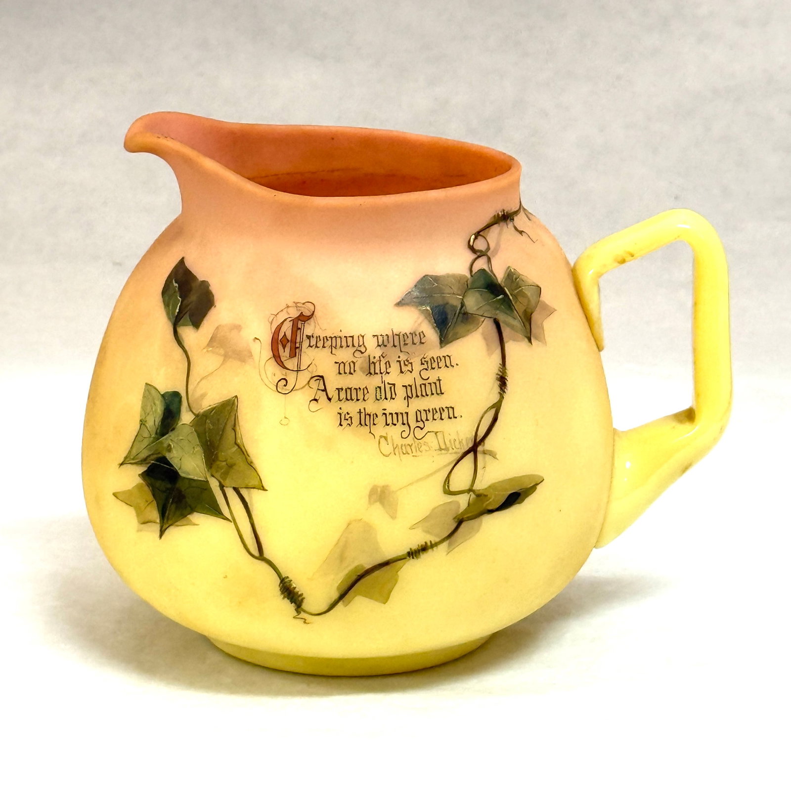 Mt. Washington Verse Pitcher: Mt. Washington Burmese pitcher decorated with a Charles Dickens Verse surrounded with ivy, 5 1/2" ht. CONDITION: no chips, cracks, repairs or material defects found, Jaremos attempts to call any mater