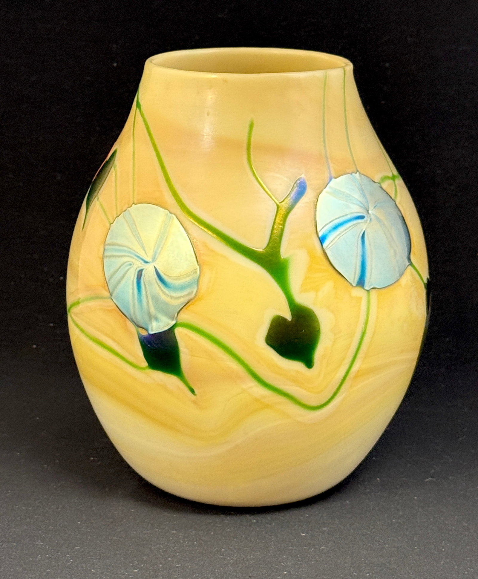 Charles Lotton Caramel Vase: Charles Lotton caramel vase with blue iridized flower and green heart leaves, signed Lotton 73; ht. 7 1/2". NOTE: Collection of Joan Allen Walker, an early collector of Lotton Glass and purchased item