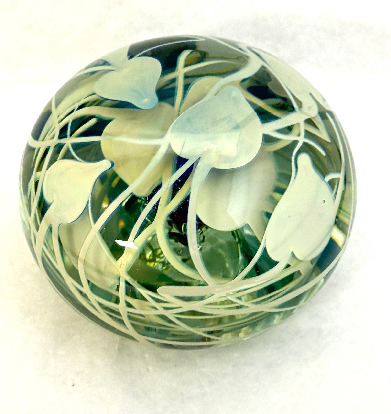 Charles Lotton Paperweight: Charles Lotton Magnum paperweight in teal glass with green hearts and vines and a crimson core, signed Charles Lotton 1973 #32, 5 1/2" wide. NOTE: Collection of Joan Allen Walker, an early collector