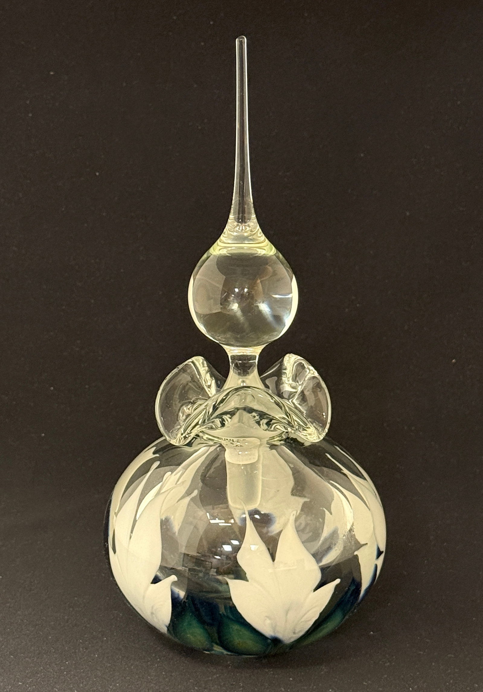 Daniel Lotton Multi Flora Perfume: Daniel Lotton translucent perfume decorated with large white multi flora with blue leaves, signed Daniel Lotton 1998, 10 1/4" ht. PROVENANCE: Humler Nolan. CONDITION: no chips, cracks, repairs, or
