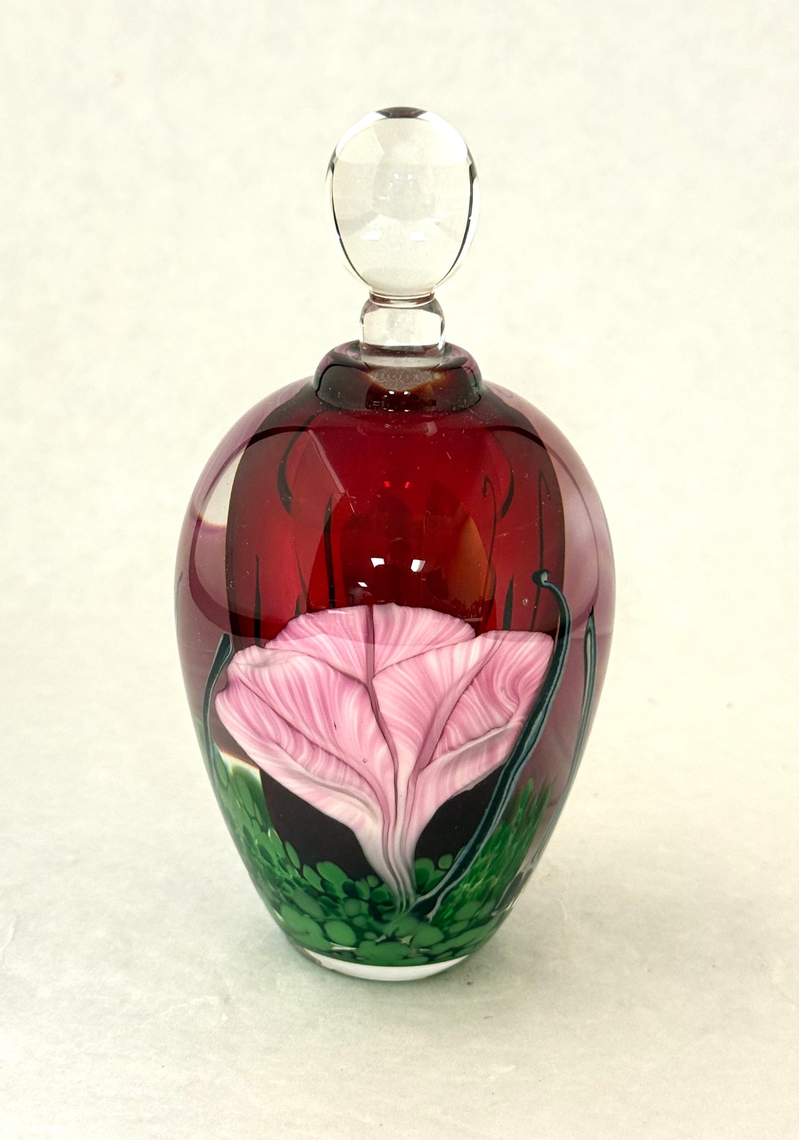 Rick Satava Red Perfume: Rick Satava red perfume decorated with pink stemmed flowers, signed R. Satava 467 92, 5 1/2" ht. CONDITION: no chips, cracks, repairs, or material defects found, Jaremos attempts to call any material