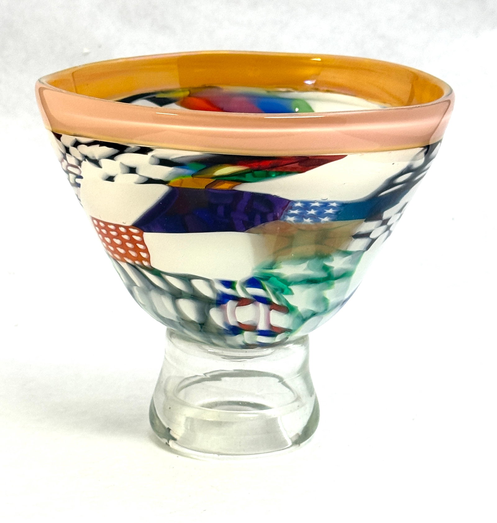 Richard Marquist Art Glass Bowl: Richard Marquist art glass bowl on clear foot and colorful geometric pattern, signed Marquist; diameter 5 3/4". CONDITION: no chips, cracks, repairs, or material defects found, Jaremos attempts to cal