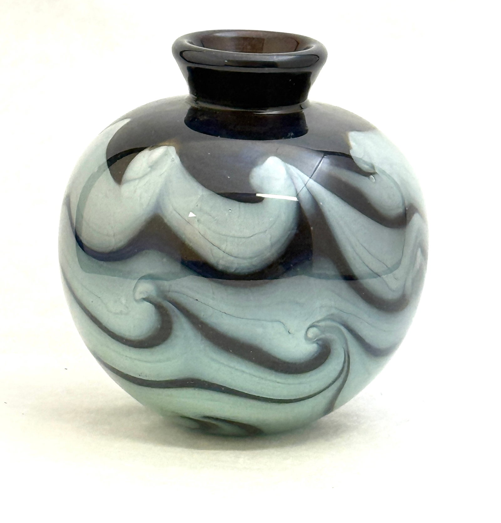 Mark Peiser Small Art Glass Vase: Mark Peiser small art glass vase with varying shades of blue undulating swirls, signed Mark Peiser 1972; ht. 5". CONDITION: no chips, cracks, repairs, or material defects found, Jaremos attempts to ca