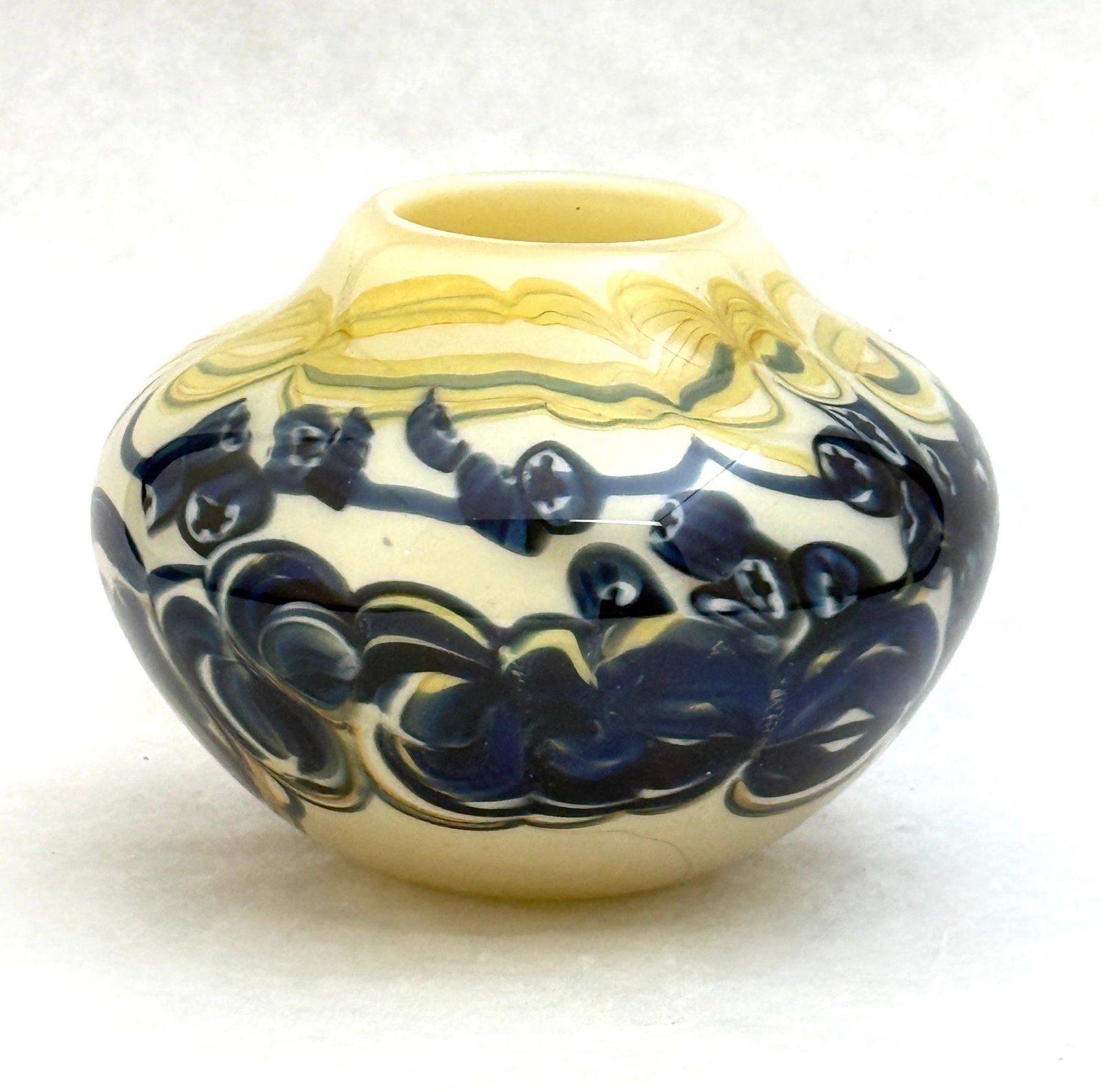 Richard Q Ritter Art Glass Vase: Richard Q Ritter squat form art glass vase opal with swirling blue and yellow/green bands, signed Richard Q Ritter 1974; ht. 4". CONDITION: no chips, cracks, repairs, or material defects found, Jaremo