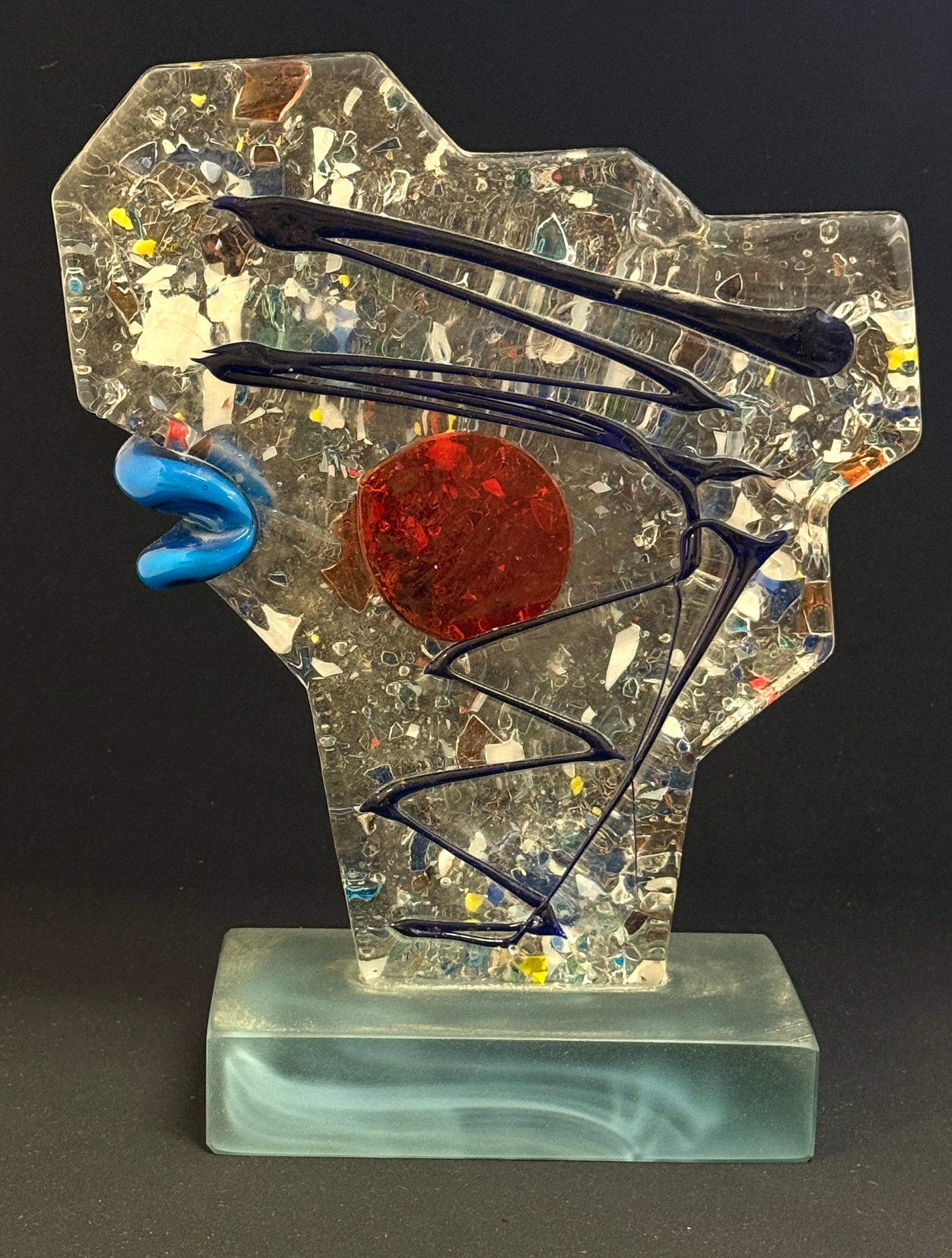 Murano Clown Sculpture: Gray footed Picasso style glass sculpture of a confetti glass clown with blue lips, carries a paper label, 14" ht. CONDITION: no chips, cracks, repairs, or material defects found, Jaremos attempts to