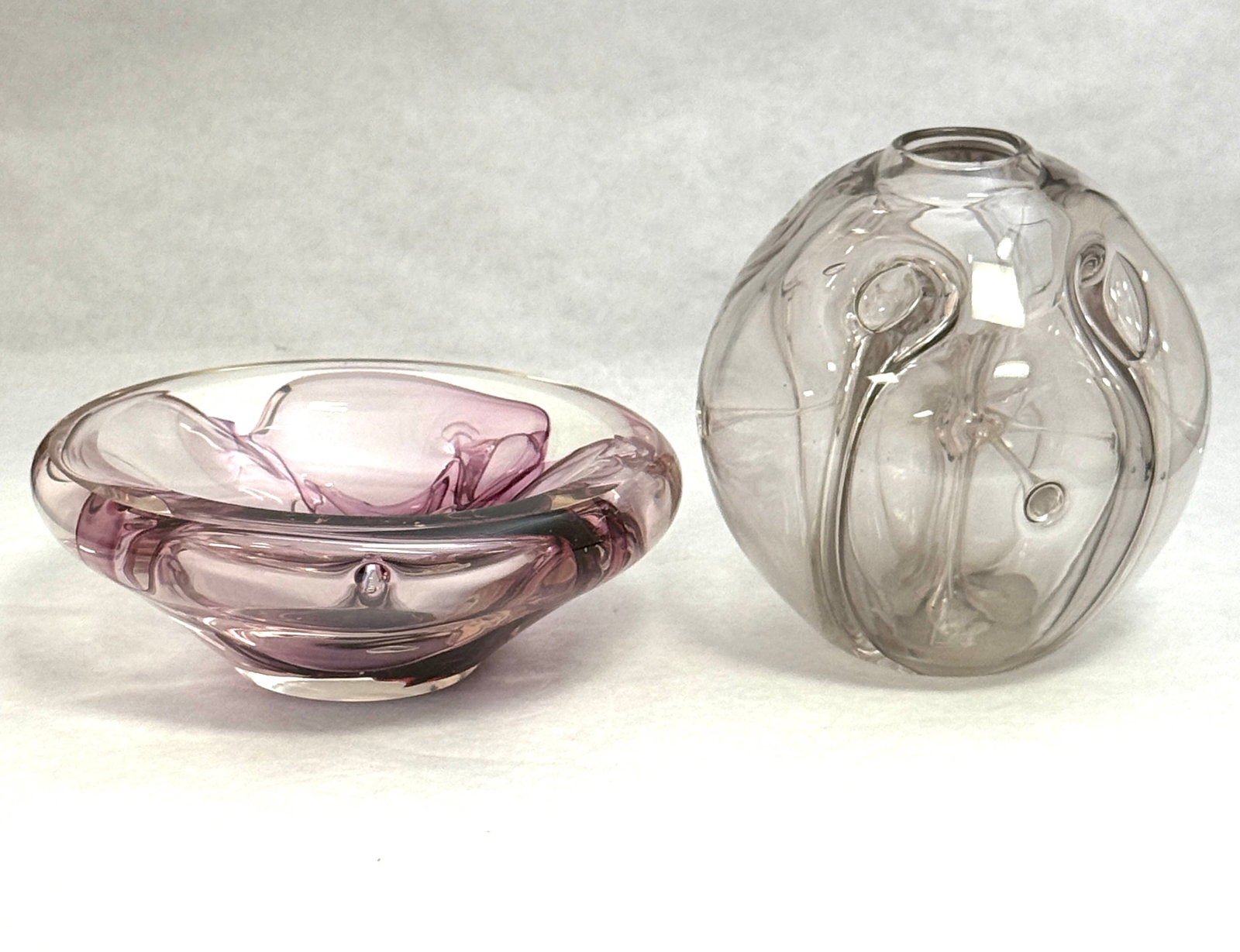 Two Paul Manners Glass Items: Two Paul Manners art glass items, including a crystal orb with internal spider together with a bowl with purple spider both signed 5 1/2" ht. CONDITION: no chips, cracks, repairs, or material defects 