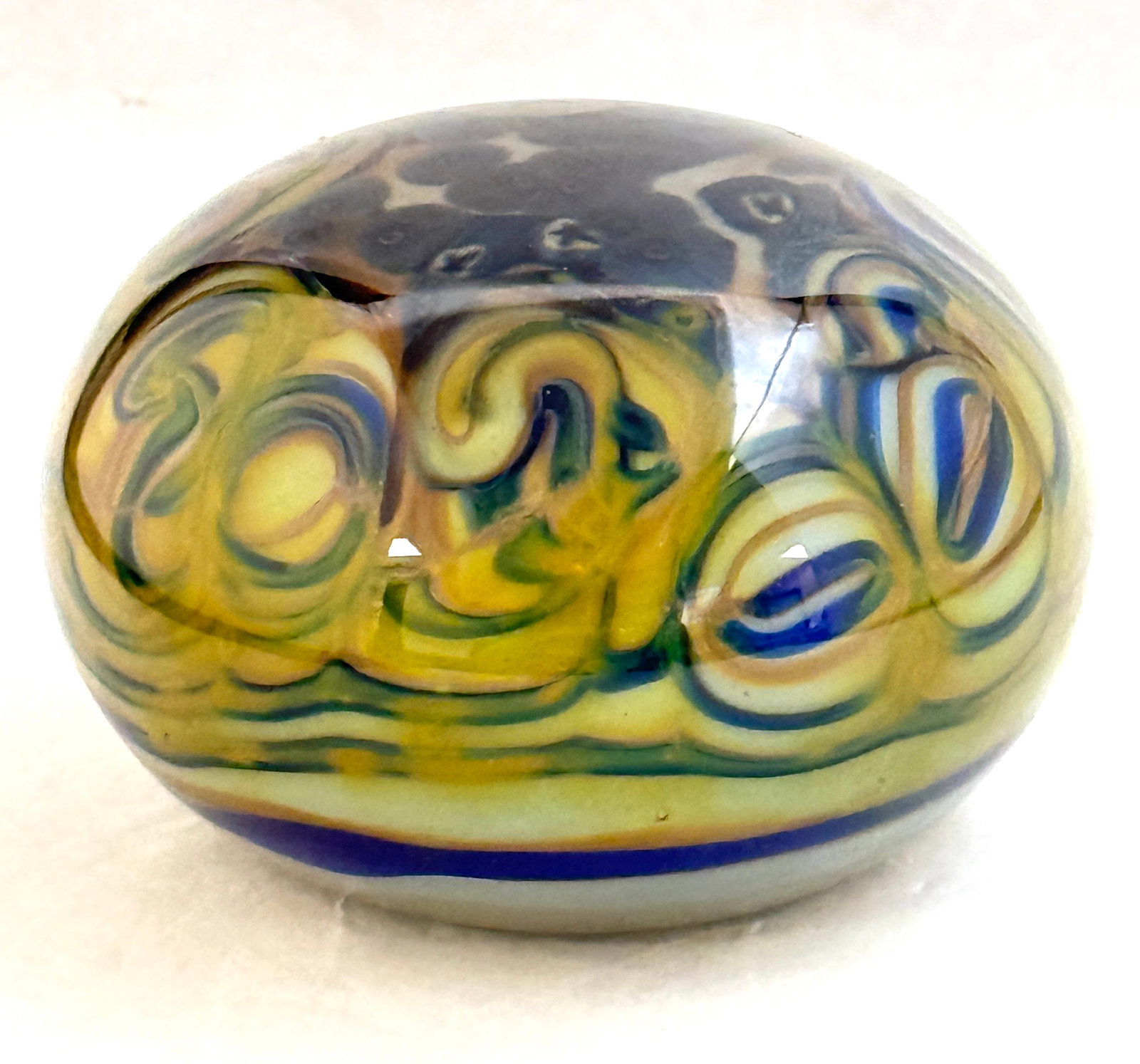 Ritter Art Glass Paperweight: Ritter art glass paperweight with shades of blue and green swirls and millefiori like shells, signed Richard Ritter; diameter 4". CONDITION: no chips, cracks, repairs, or material defects found,