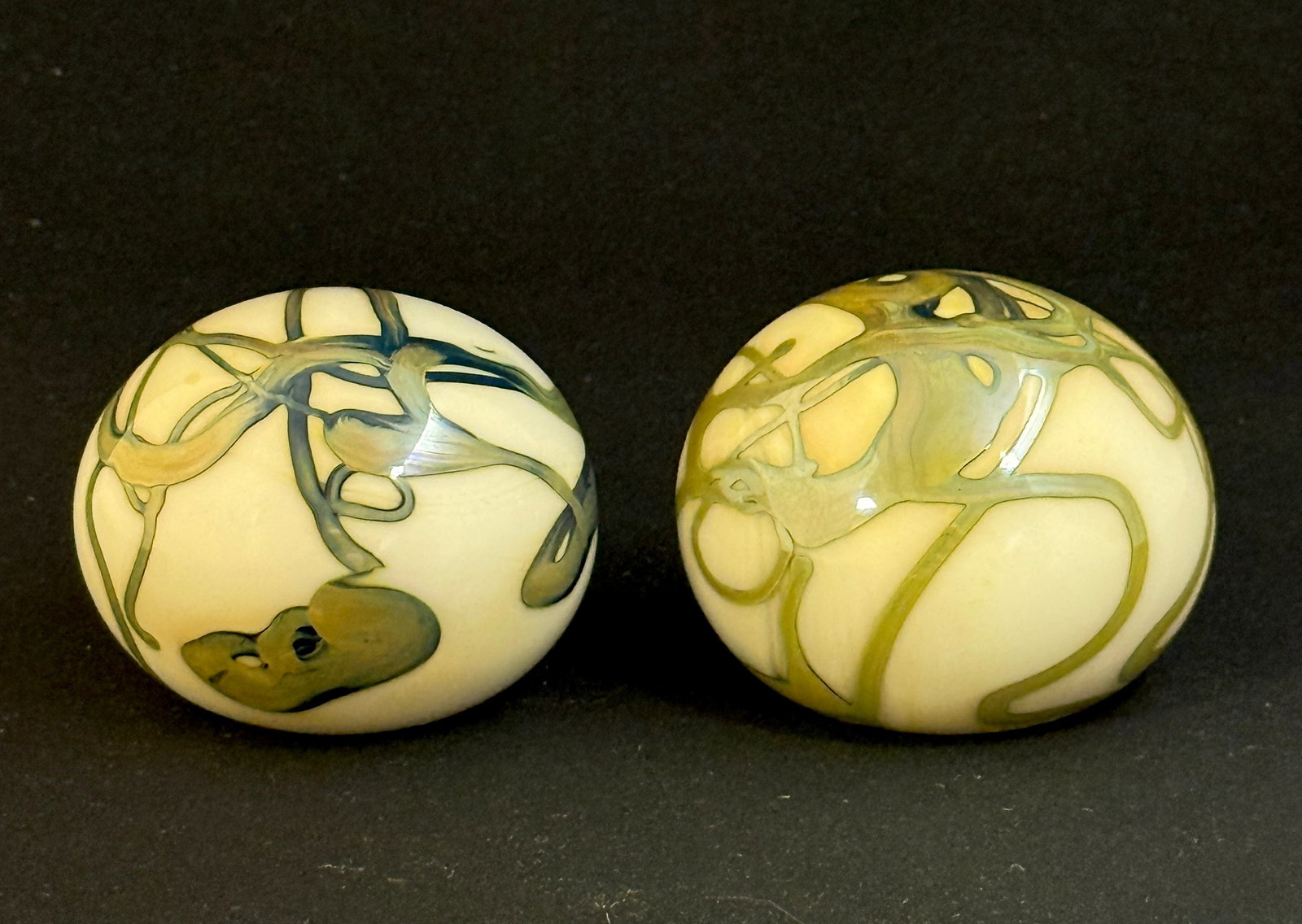 2 John Byron Paperweights: 2 John Byron opal with green swirling ribbons paper weight, signed Jbryon; diameter 2 1/2". CONDITION: no chips, cracks, repairs, or material defects found, Jaremos attempts to call any material flaw