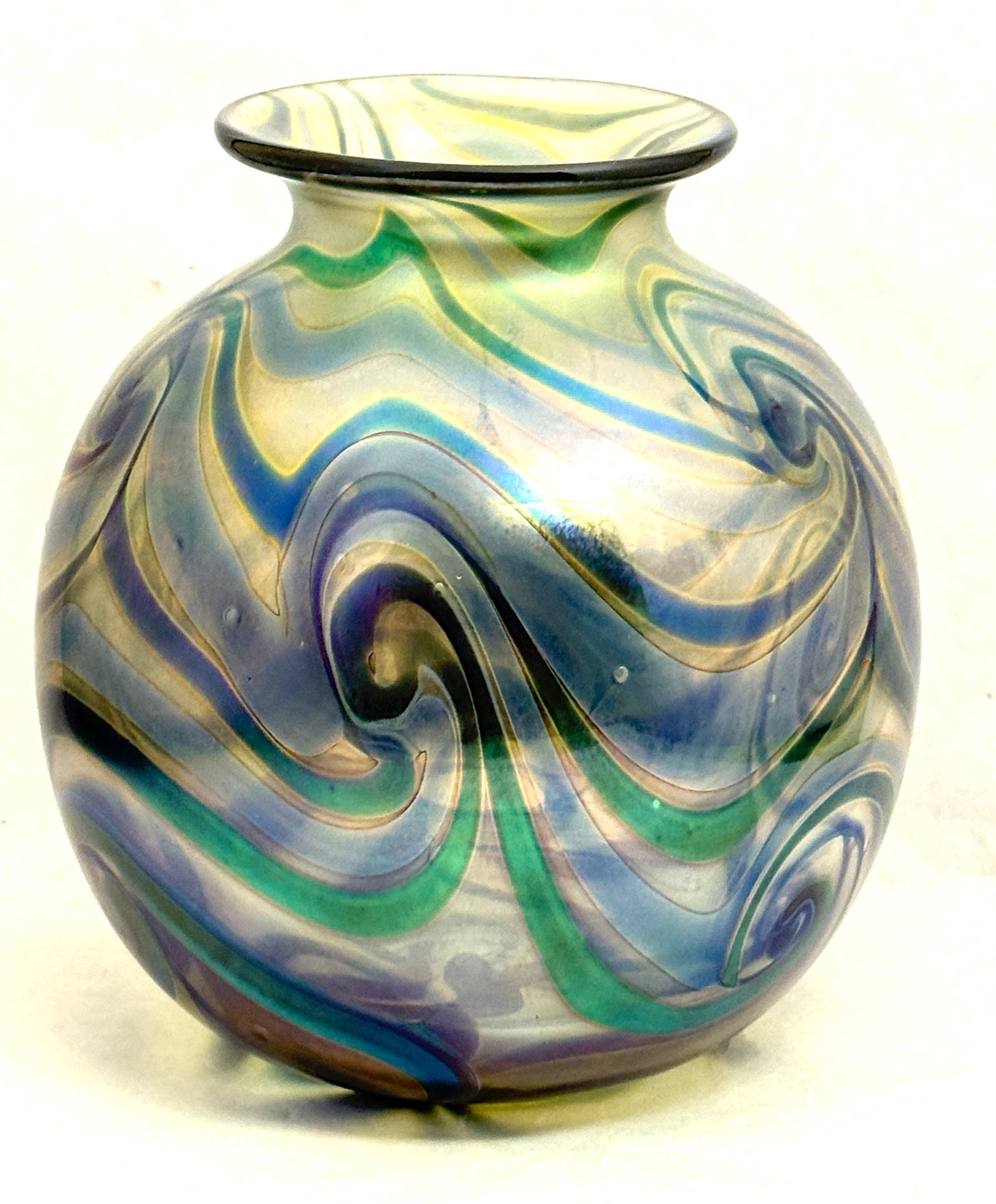 Charles Lotton Glass Orb: Charles Lotton translucent orb vase with an iridescent green and blue coil design, signed Lotton 1972 #613, 7 1/2" ht. NOTE: Collection of Joan Allen Walker, an early collector of Lotton Glass and pur