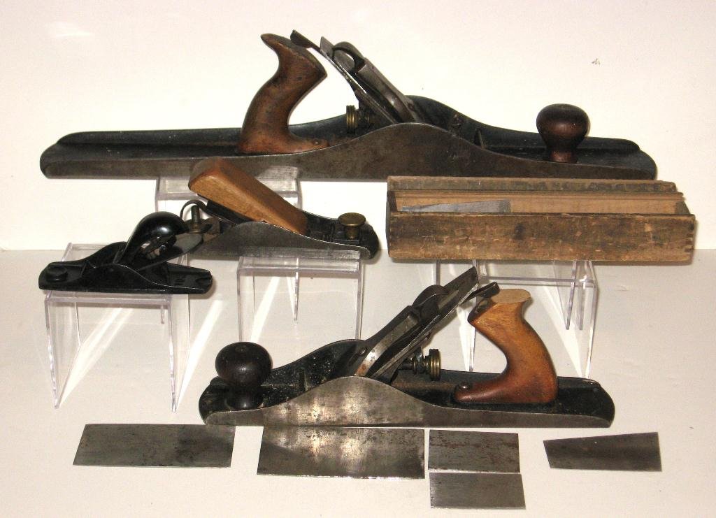 Group of Four old Stanley planes and blades,: including a Stanley Bailey #7, Stanley #102, and a Stanley #5, together with a hand made box with extra blades and parts, longest 21" long.