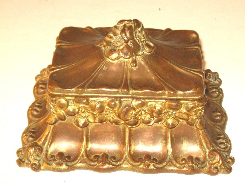 Copper Art Nouveau dresser box,: gilt finished rectangular form with flower embossed border and finial, appears to be copper, 7" long.