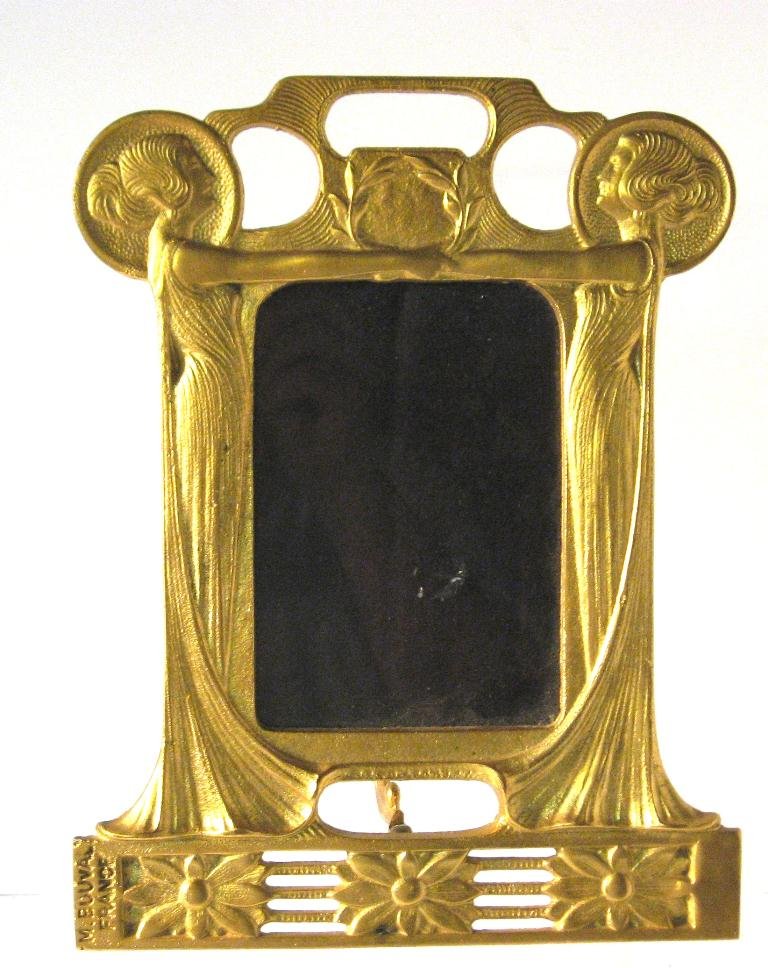 Art Nouveau Gilt metal standing mirror,: gilt metal (bronze?) Art Nouveau mirror framed with two standing women holding hands and a band of flowers at the foot, stamped M. Bouval France, 10 1/2" ht.