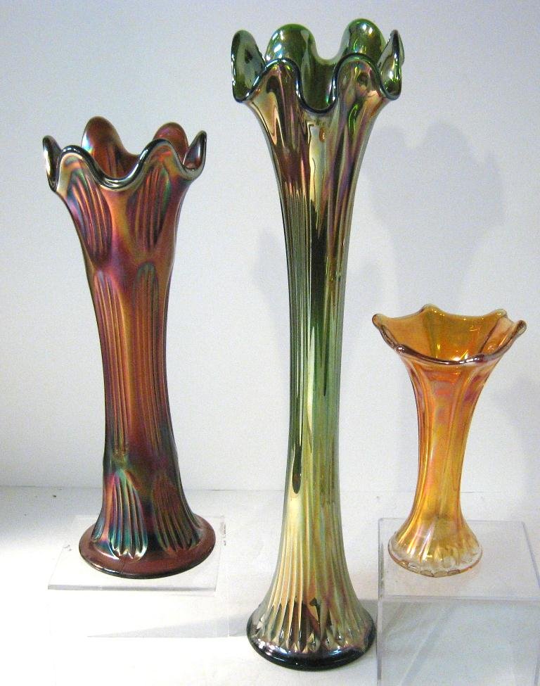 Three Carnival Swung vases,: Including a monumental Northwood green Fine Rib, a Fenton amethyst "Diamond and Ribbing", and a marigold flute, tallest 17" ht.