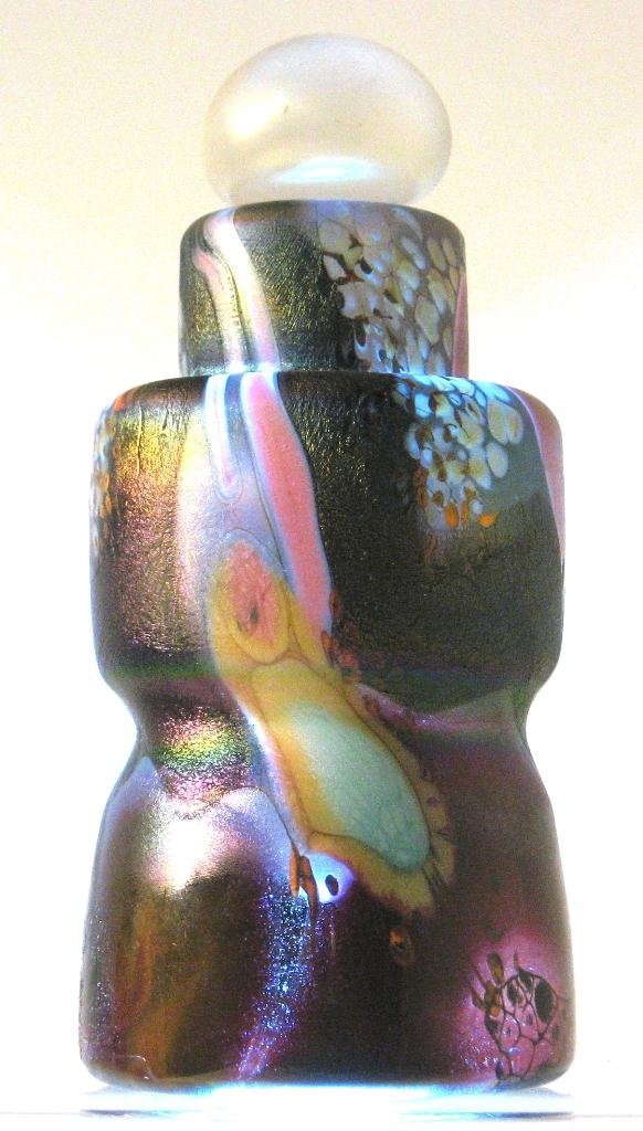 Joel Philip Myer iridescent perfume bottle,: corset cylindrical form in aventurine crimson decorated with splattered red and blue free form medallions, signed Joel Philip Myer 1976, 6" ht.