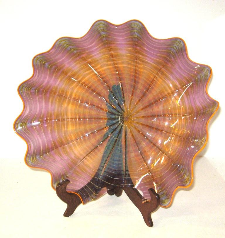 Dale Chihuly AS IS shell form dish,: excellent shading of opalescent purple and amber with red lip wrap, unsigned, large chip but displays well, 15" wide.