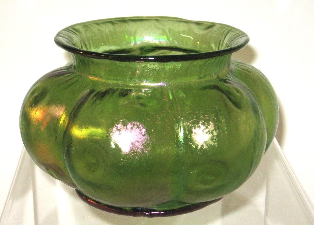 Loetz green iridescent glass bowl,: lobed form with an everted rim in iridescent green decorated with pig tail prunts, 6 1/2" wide.
