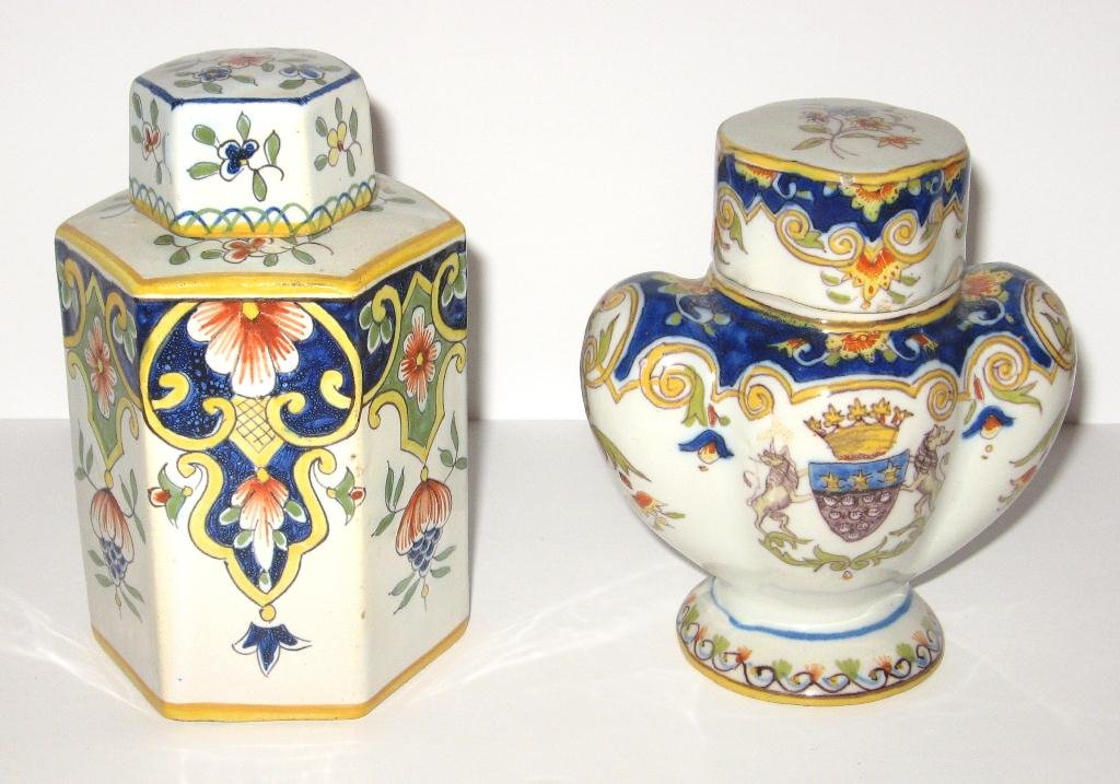 (2) Desvres French faience tea caddies,: one six-sided, Rouen dŽcor, tea caddy marked "FE", 5" ht.; one unmarked Desvres caddy in Rouen dŽcor with blason of Mt. St. Michel. 5" ht. c.1900.