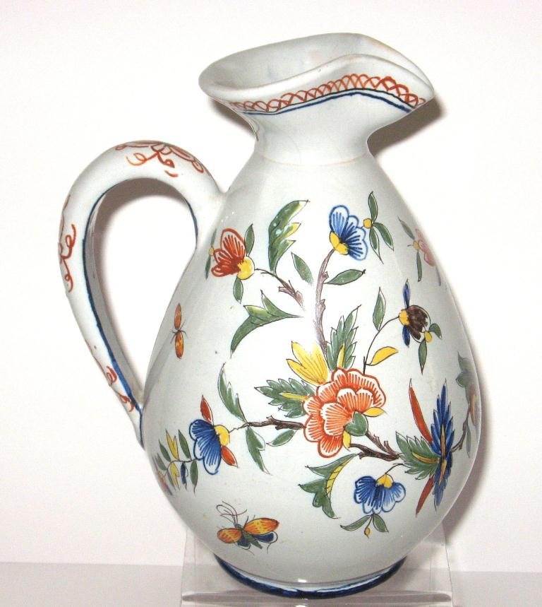 French faience wine pitcher with Rouen dŽcor,: with floral and butterfly motifs. Marked "SC." 8" ht. 20th C.