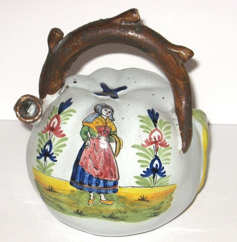 Leroy-Dubois Malicorne faience Calvados jug,: with dimensional leaf, twig-form handle and Bretonne. 7 1/4" ht. c. 1900.