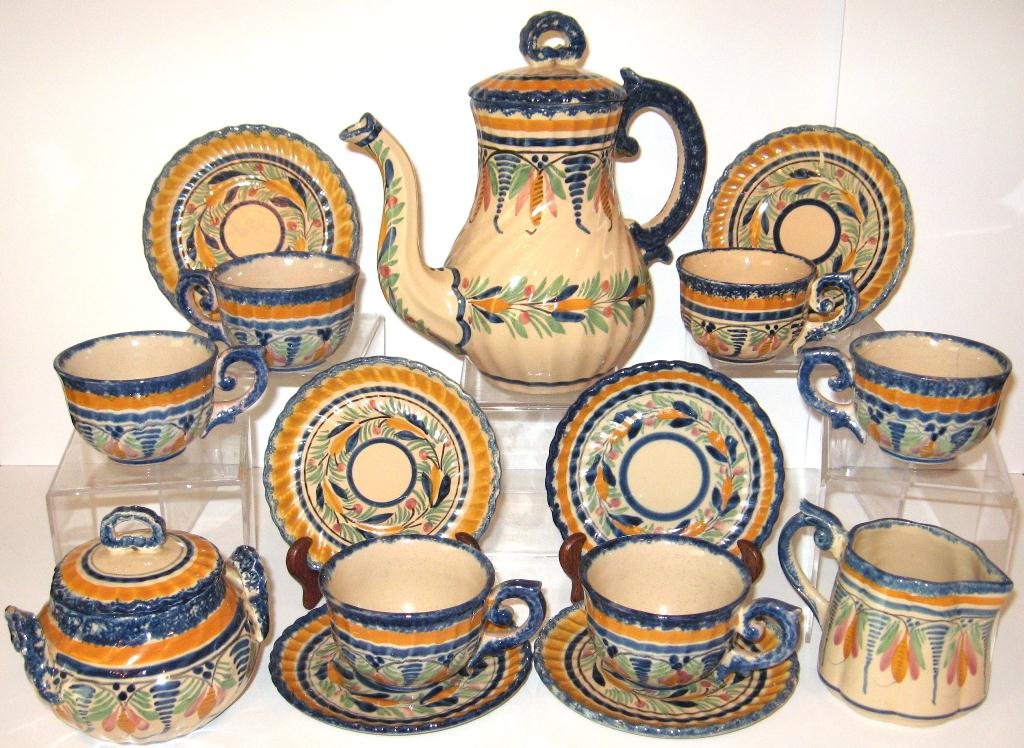 HenRiot Quimper faience 15 pc. coffee set,: including coffee pot, covered sugar, creamer, six cups and six saucers. Ivoire colored ground decorated with a la touche stylized flowers and geometrics. 9 1/2" ht. c.1930.